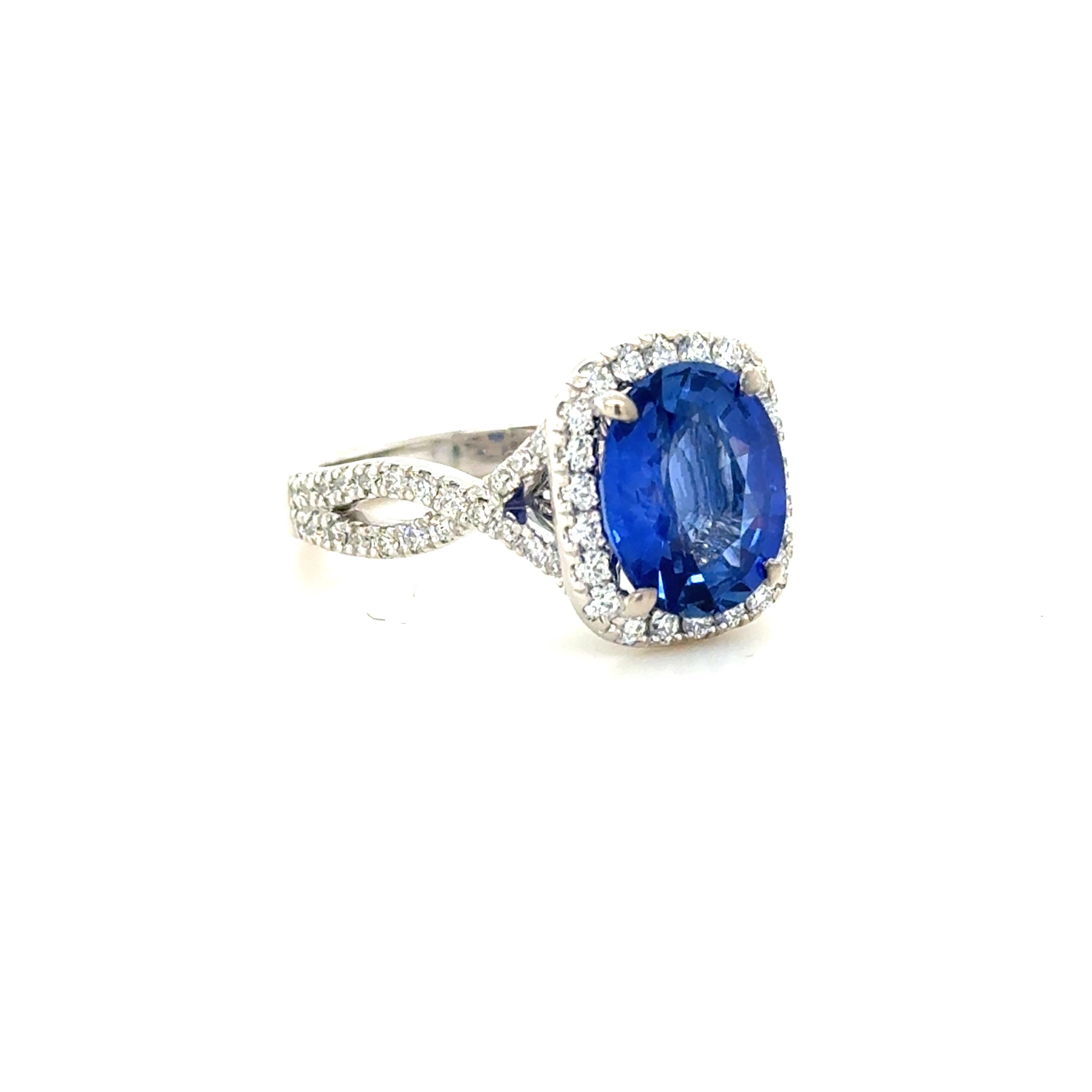 This stunning ring contains an oval mixed cut Ceylon sapphire weighing 3.11 carats and measuring 10.14 x 8.15 x 4.33 mm, surrounded by 68 top quality round brilliant cut diamonds weighing approximately 1.02 carats total. Mounted in a beautifully