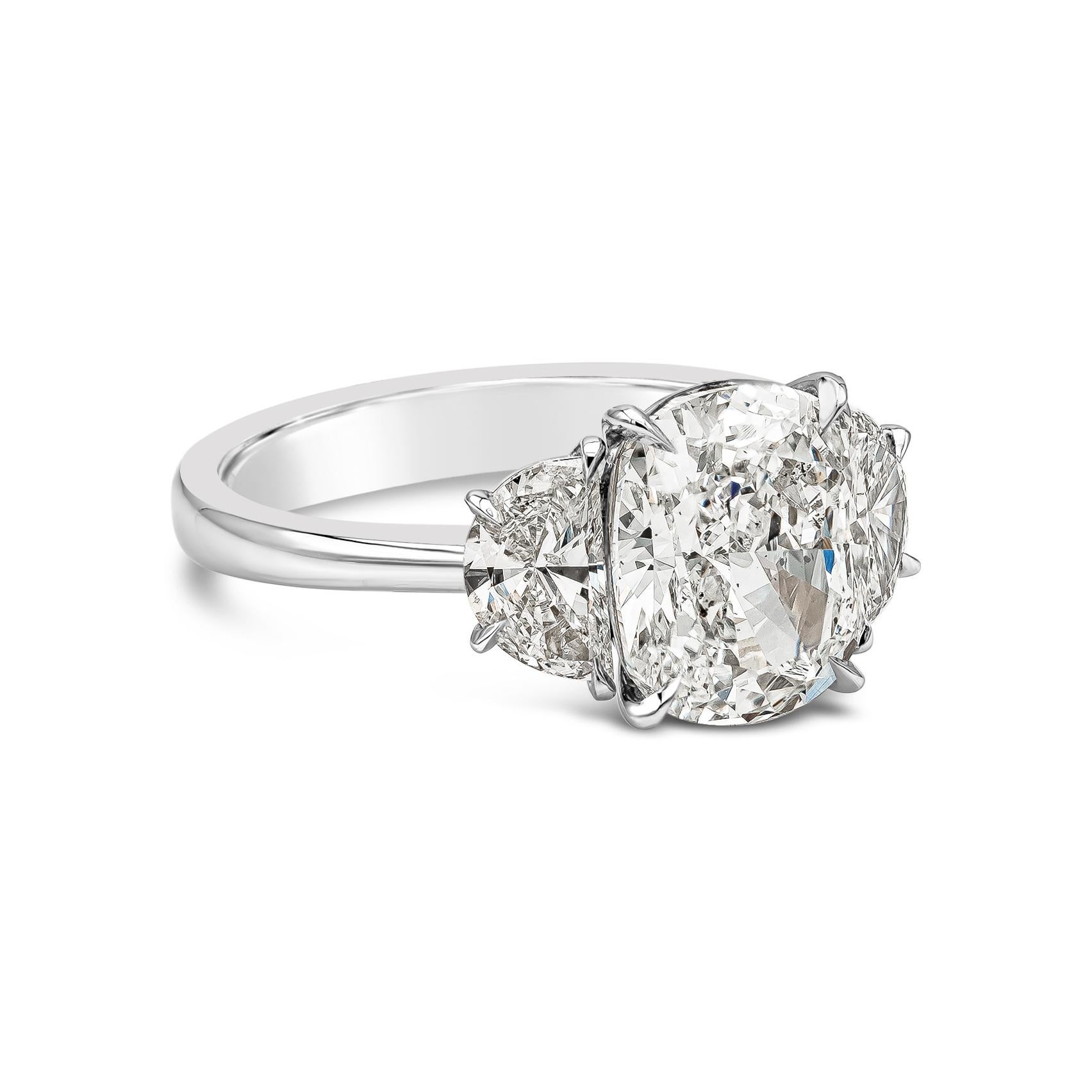 A beautiful engagement ring, showcasing a 3.11 carats brilliant cushion cut diamond certified by GIA as H color and SI1 clarity, accented by two brilliant half moon diamonds weighing 0.90 carats total. Set in a polished platinum mounting. Size 6.75