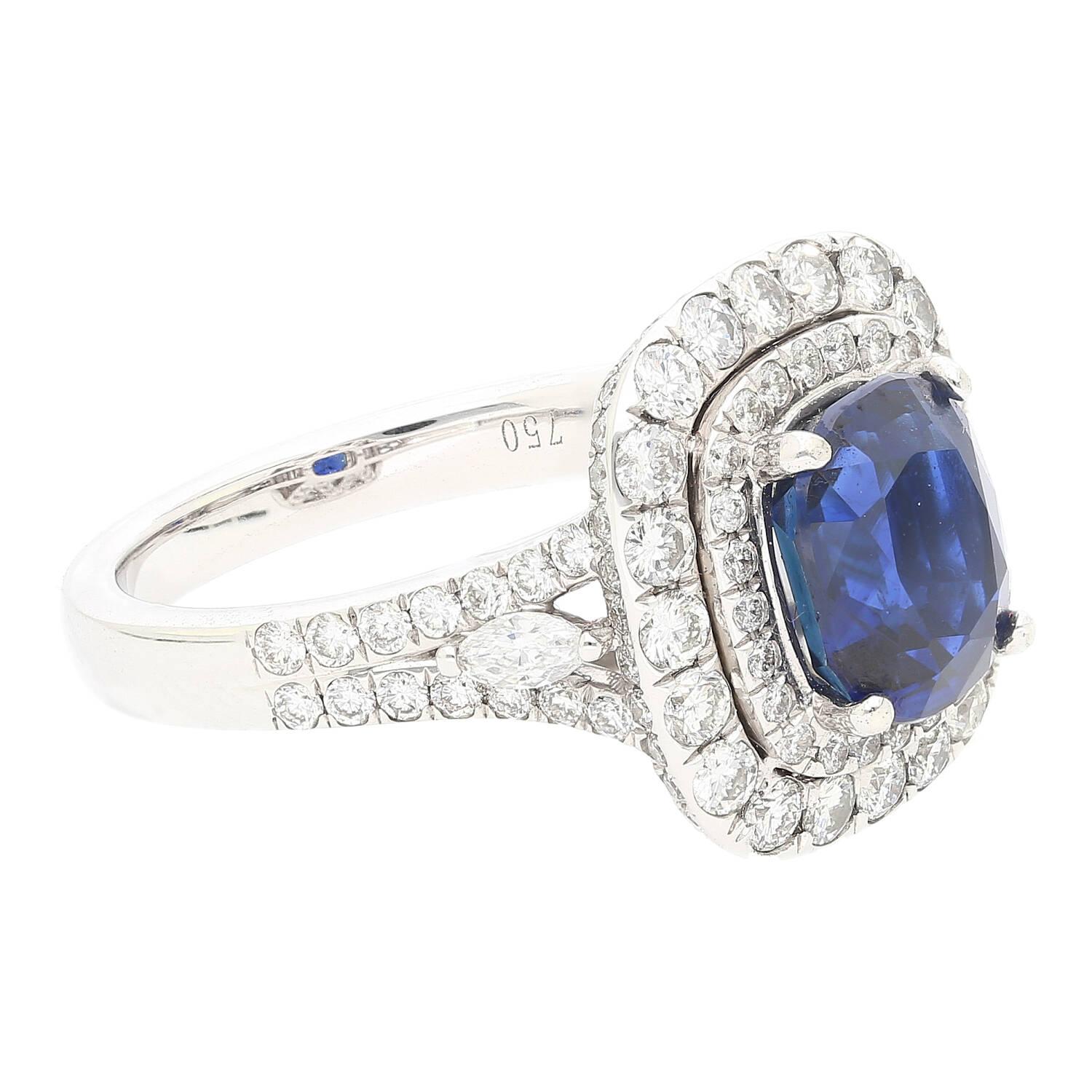GIA certified 3.12 carat cushion-cut unheated blue sapphire and round cut double diamond halo in 18k white gold. 

Every gemstone is natural, mined, and untreated with any color or clarity enhancements. The diamonds are eye-clean and superbly white.