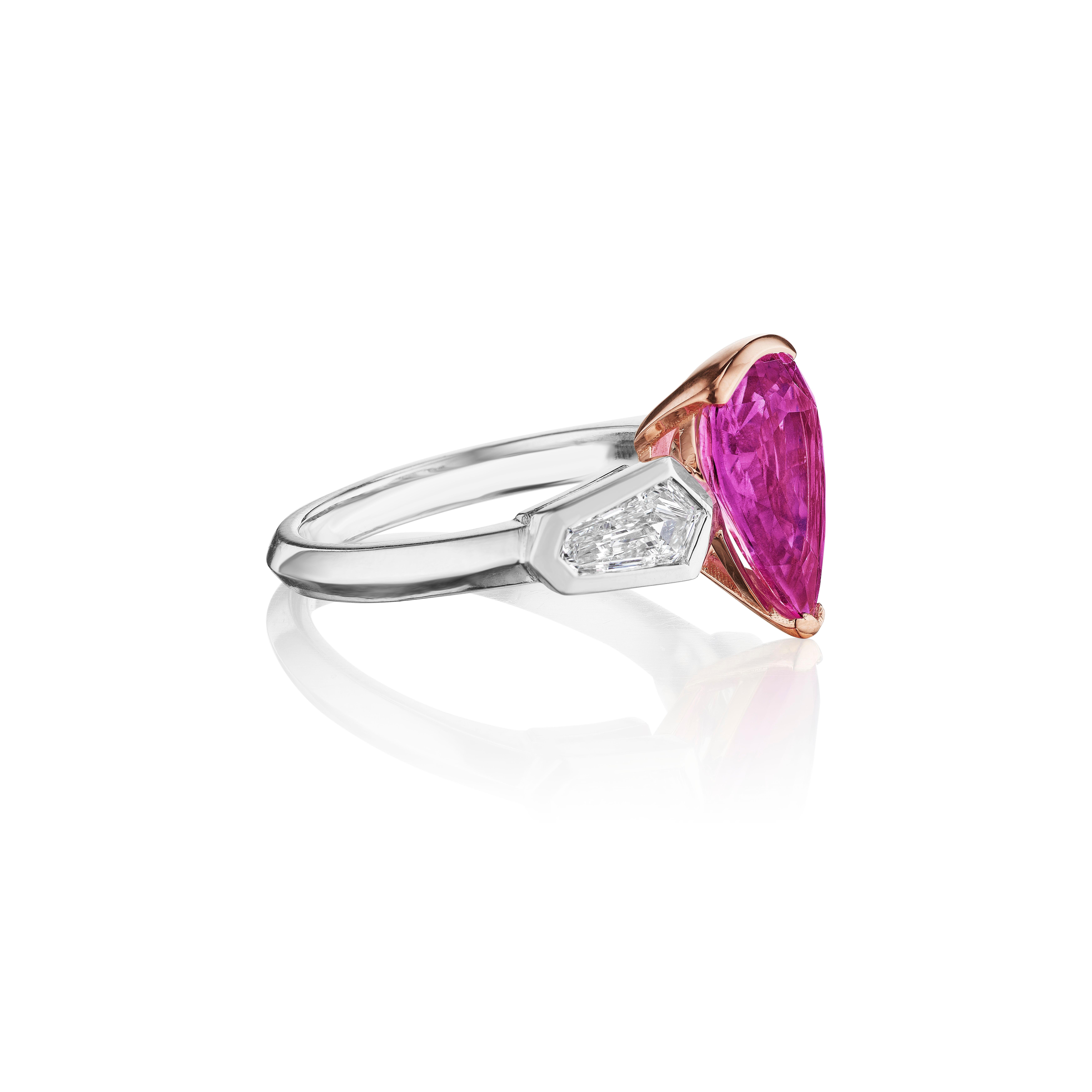 Pink Sapphire and Diamond Three Stone Ring. 

Centered upon a Cushion Cut Pink Sapphire weighing 3.12 Carats with GIA certificate stating the stone is heated and from the mines of Madagascar. 
Flanked by Kite Shaped Diamonds weighing 0.68 Carats of