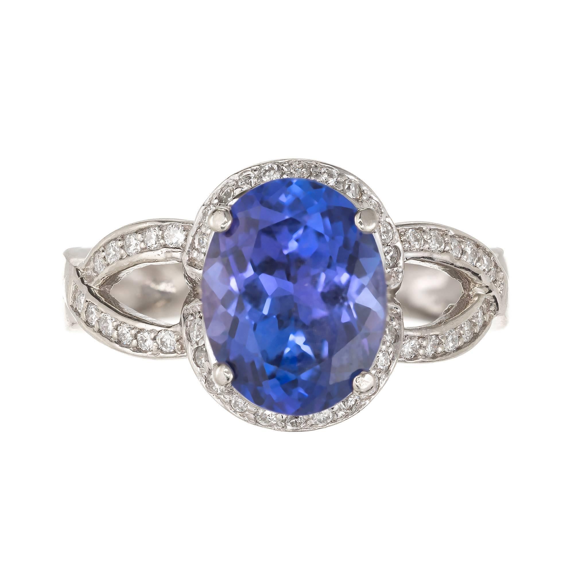 Oval Well-polished 3.14ct Tanzanite and diamond cocktail ring. 14k white gold setting with oval Tanzanite center stone, surrounded by a halo of diamonds. 

1 oval violet blue Tanzanite, approx. total weight 3.14cts, VS2, 10.80 x 8.30 x 5.45mm, GIA