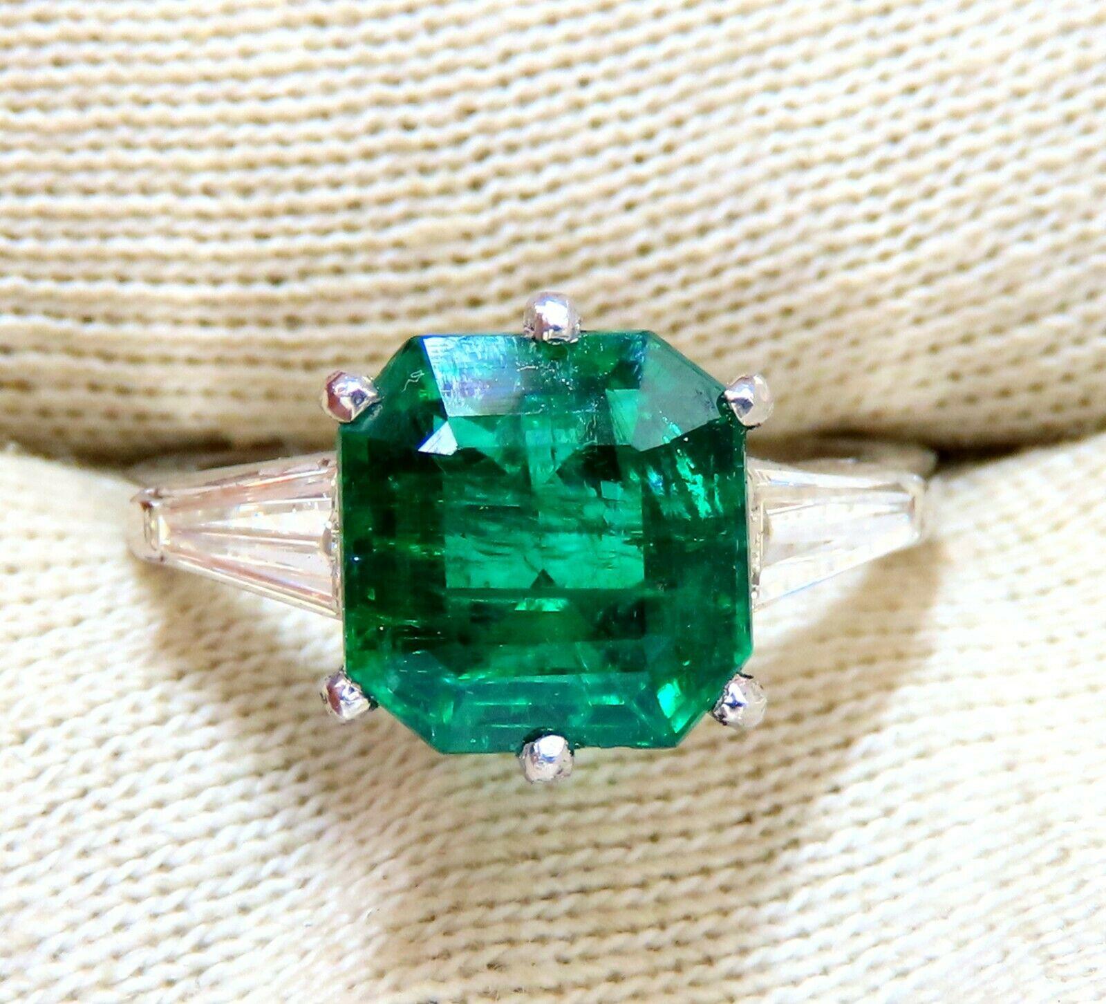 Halo Green.

3.16ct. Natural Emerald Ring GIA Certified: #2215617128(To Accompany)

9.01 X 8.78 x 5.38mm

Full cut Emerald Cut brilliant

Clean Clarity & Transparent

(F3) Vivid Green / Zambia Best

.50ct. Diamonds.

Round & full cuts G-color Vs-2