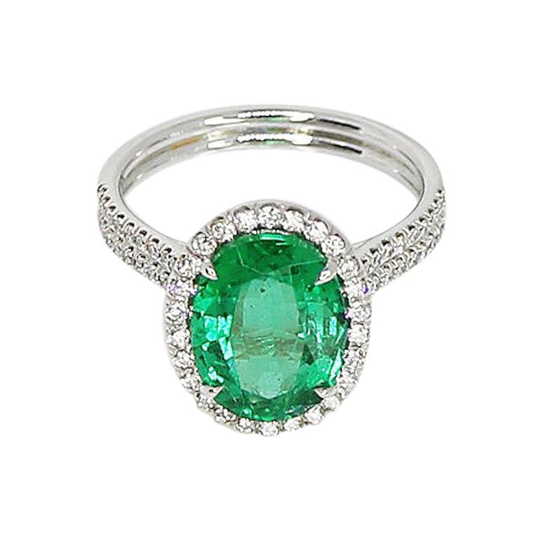 GIA Certified 3.17 Carat Oval Emerald and Diamond Halo Ring For Sale