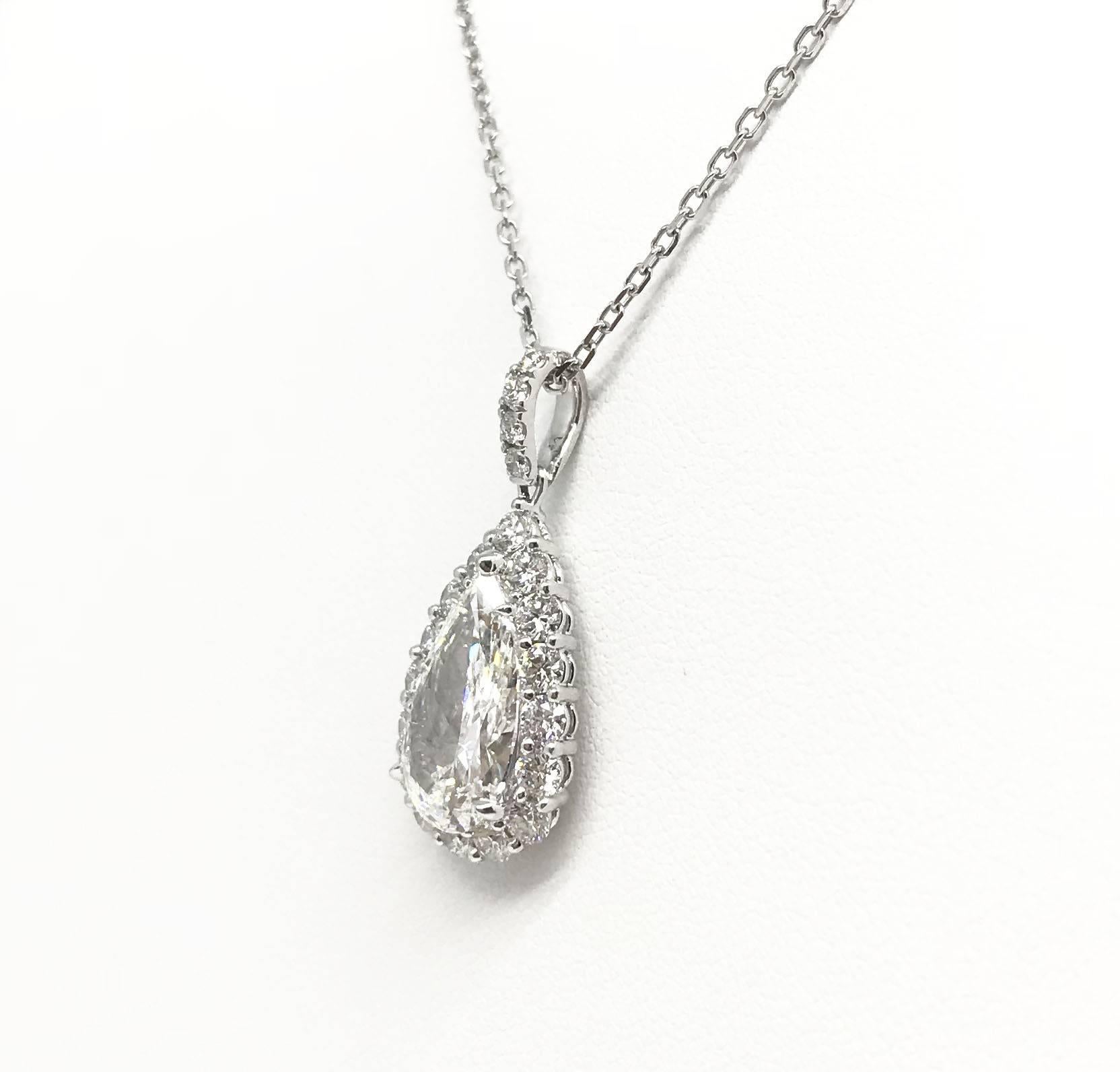 An exquisite H Colour 3.17 carat VS1 pear shaped diamond, surrounded by 1.07 carat pave setting diamonds is an irresistible choice for her. The piece is set in Platinum. Chain not included.

