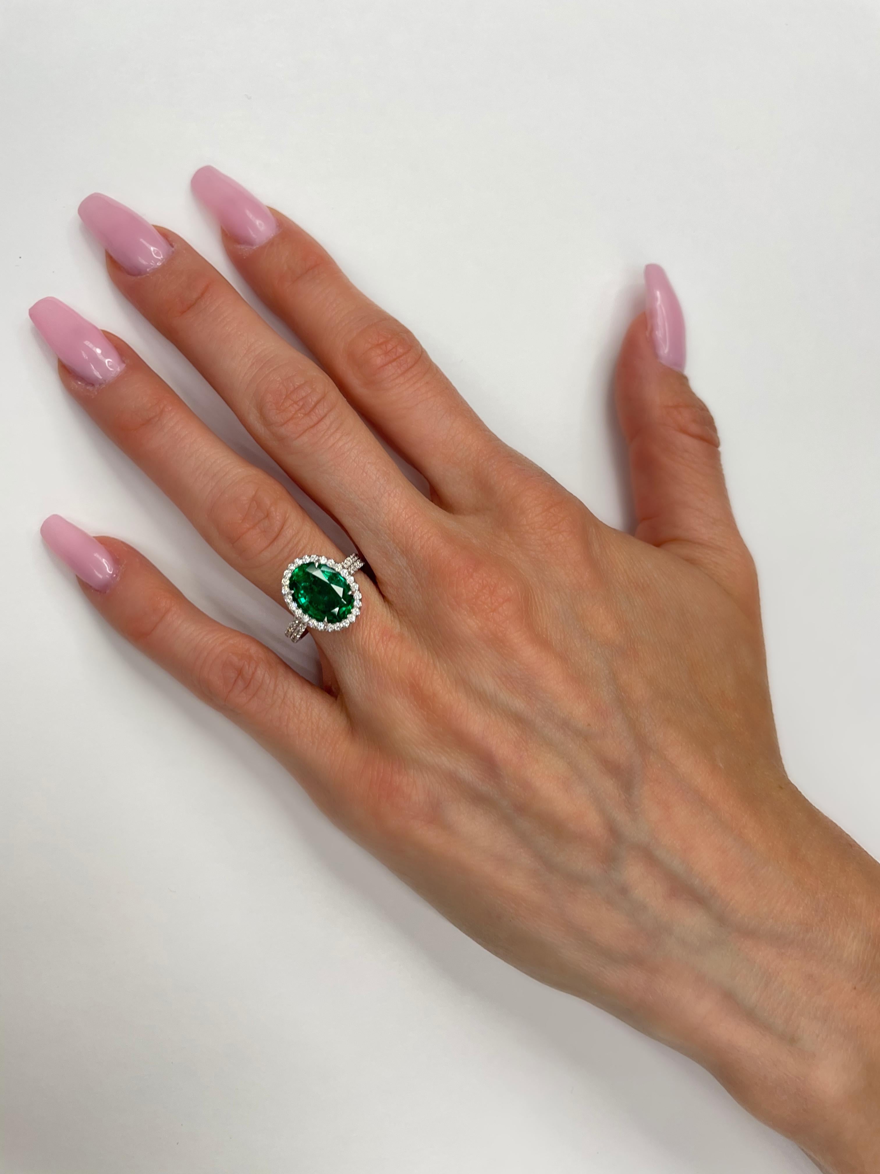 This 3.17ct Oval Cut Green Emerald is set in 18K white Gold surrounded by 122pcs Round G-VS =0.55cttw GIA certified #5121892595