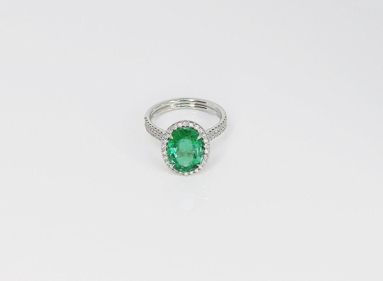 Contemporary GIA Certified 3.17 Carat Oval Emerald and Diamond Halo Ring For Sale