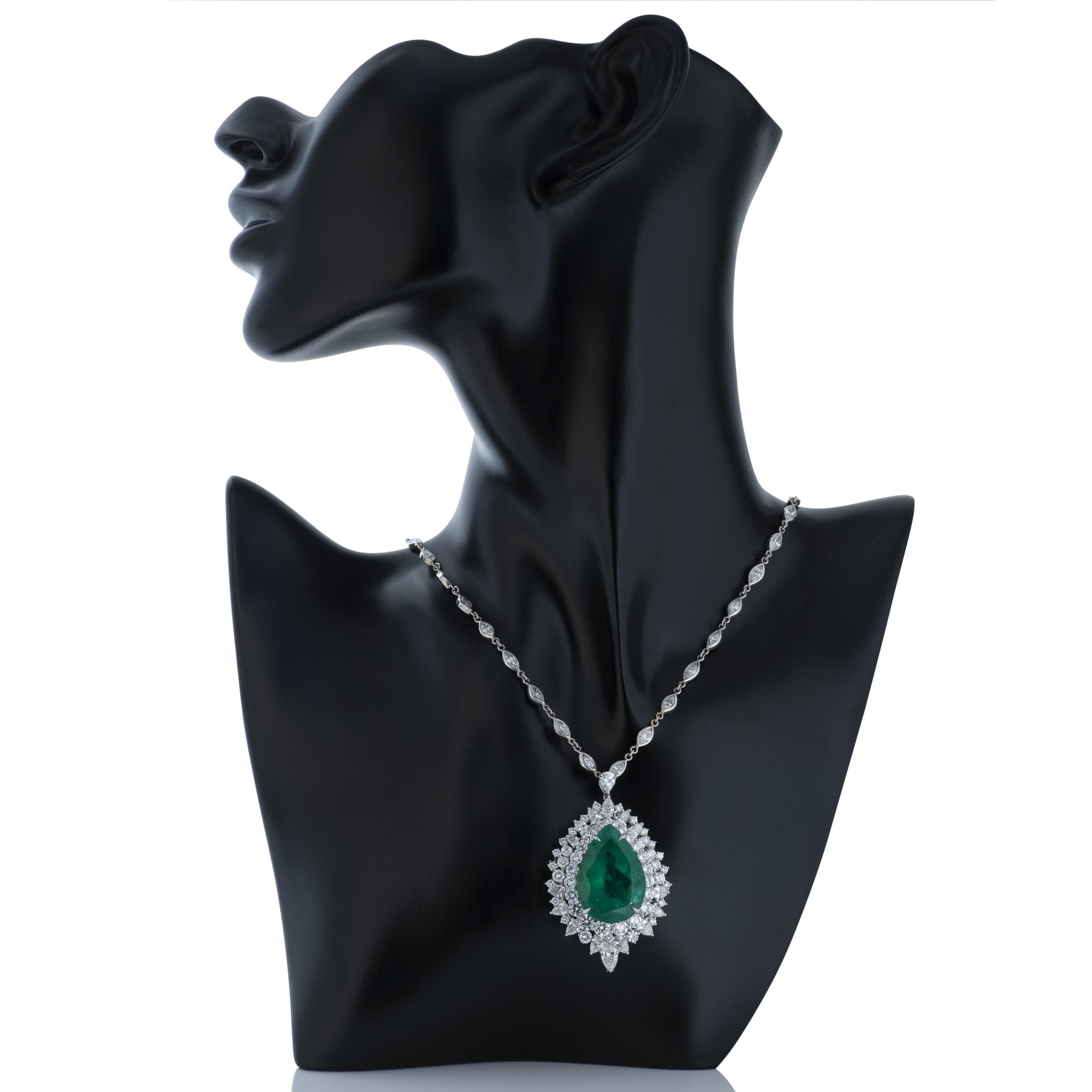 Platinum Colombian emerald and diamond pendant hanging from an 18k white gold marquise shape diamond by the yard style chain.  

This pendant contains a GIA certified 31.98 carat pear shape Colombian emerald surrounded by 17 pear shape and 50 round