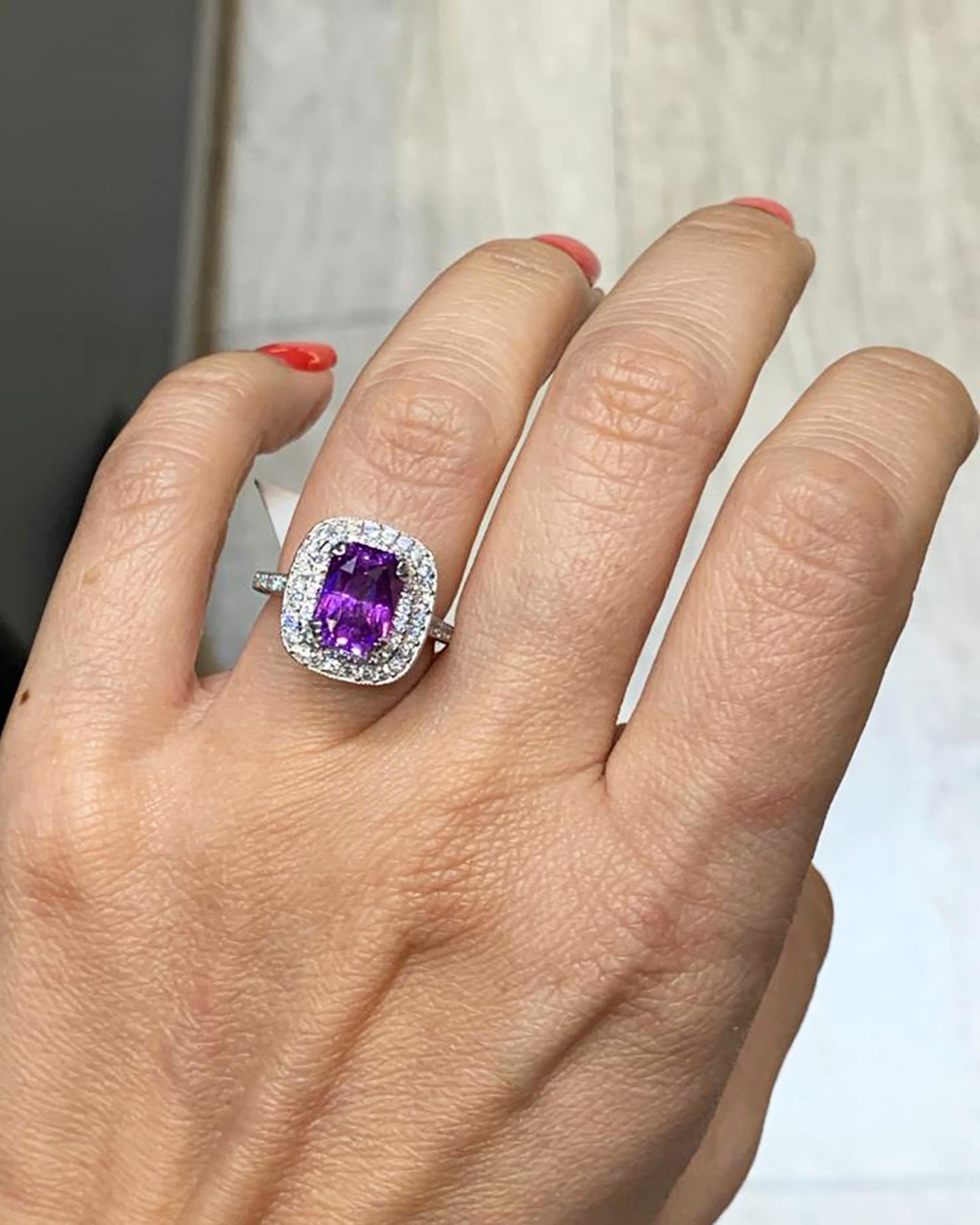 Indulge in the allure of this exquisite cocktail ring, where luxury and craftsmanship harmoniously come together to create a statement piece of exceptional beauty. At the heart of this ring lies a mesmerizing 3.21 carat purple sapphire, a rare