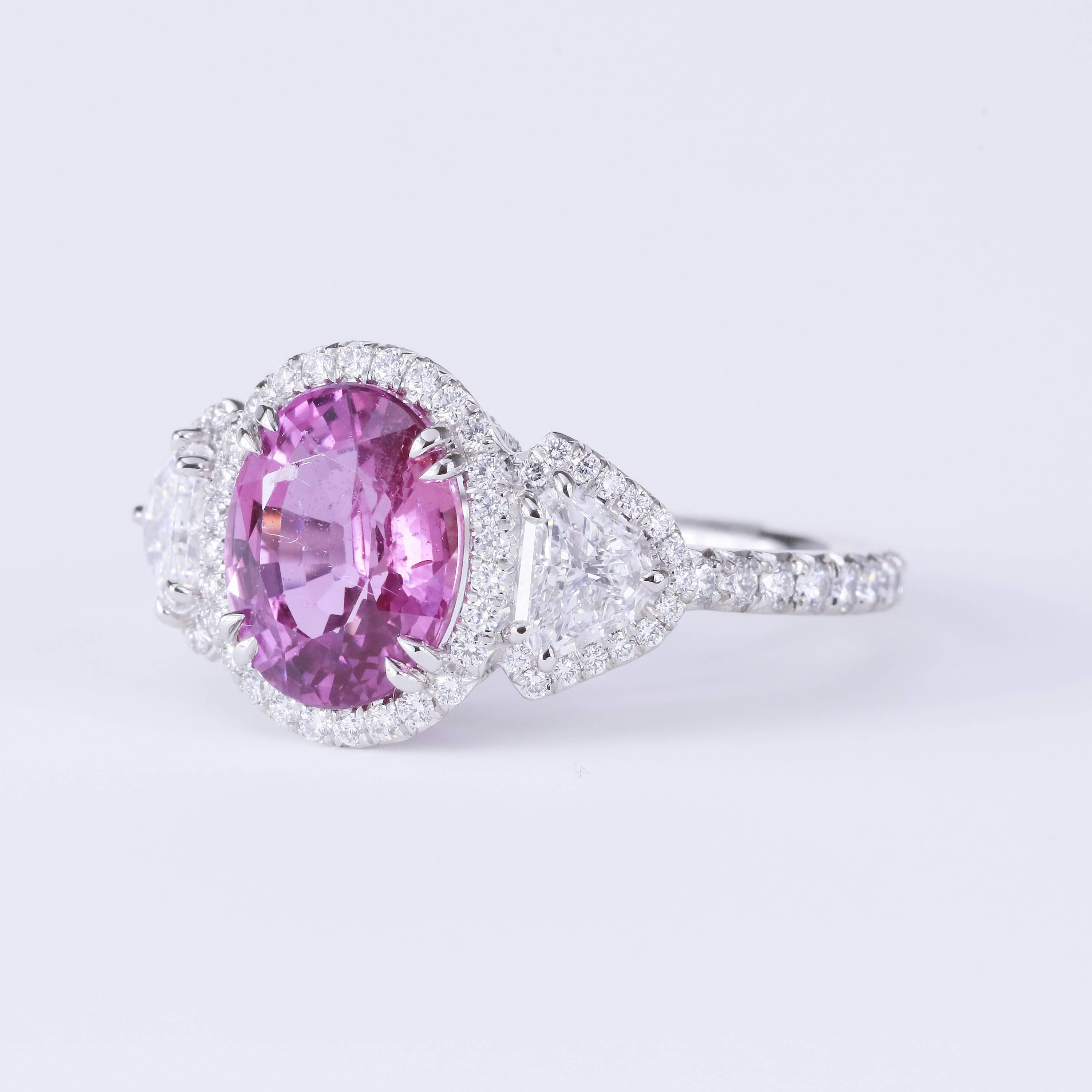 3.23 ct purple-pink natural sapphire oval center
Shield side stones D VS1 0.65 tw (2 stones)
Round diamond melee on halo, gallery and shank 0.61 tw (134 stones)
Platinum 3 stone ring
Size 6.25
