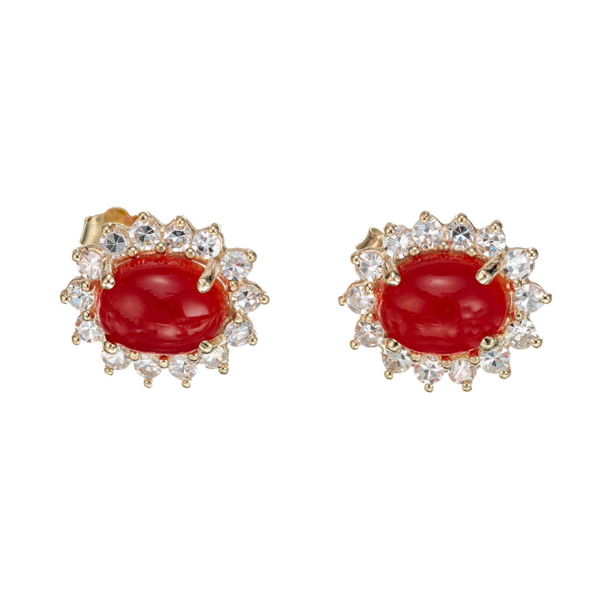Natural red orange coral and diamond earrings set in 14k yellow gold. Two GIA Certified natural 9x7 red orange coral cabochons, each with a halo of single cut diamonds. 

2 oval cabochon orange red coral, approx. 3.25cts GIA certificate#