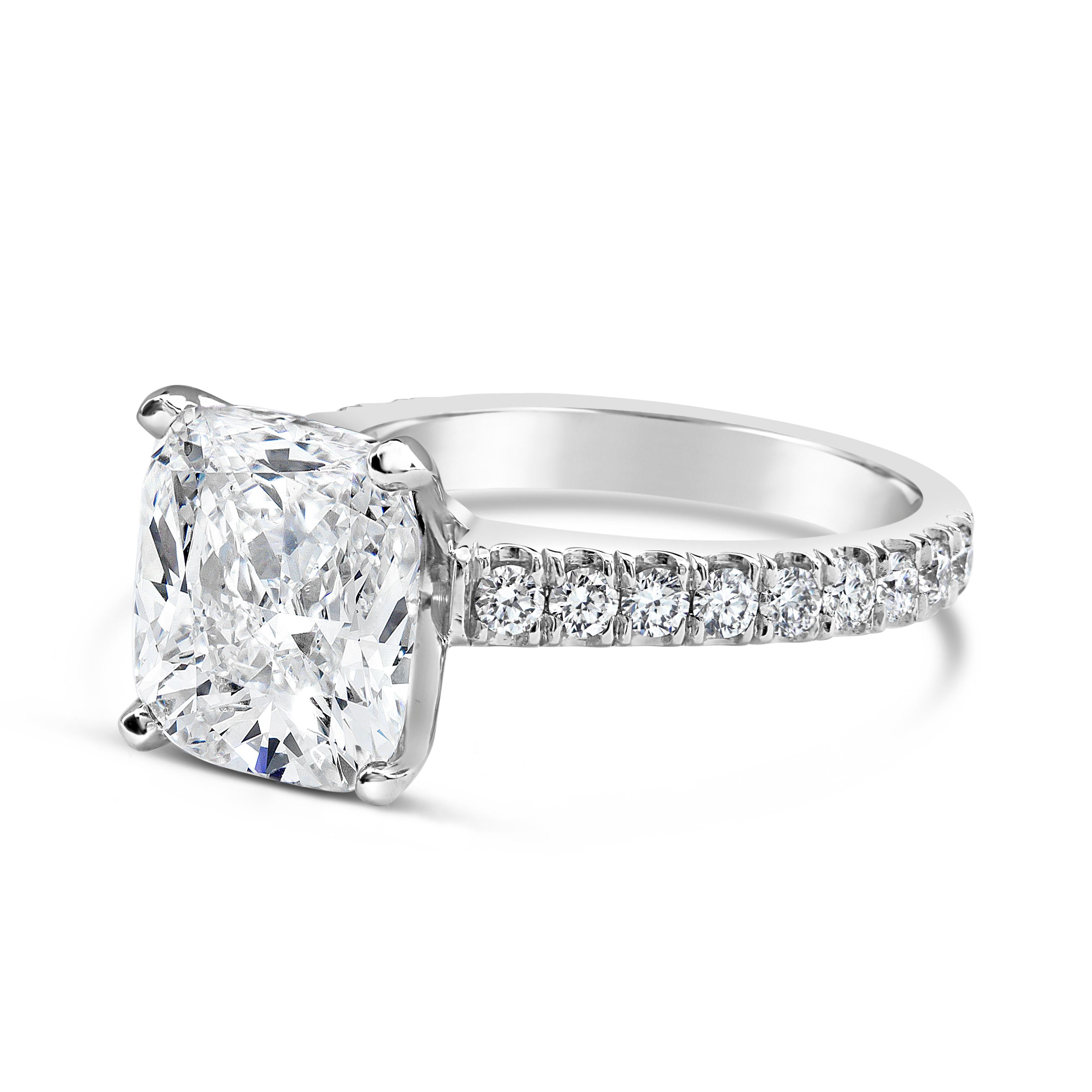 An elegant engagement ring, showcasing a 3.25 carats cushion cut diamond certified by GIA as G color and SI1 clarity, set on a four prong basket. Accented with a diamond encrusted shank in a semi infinity setting. Accent diamonds weigh 0.50 carat