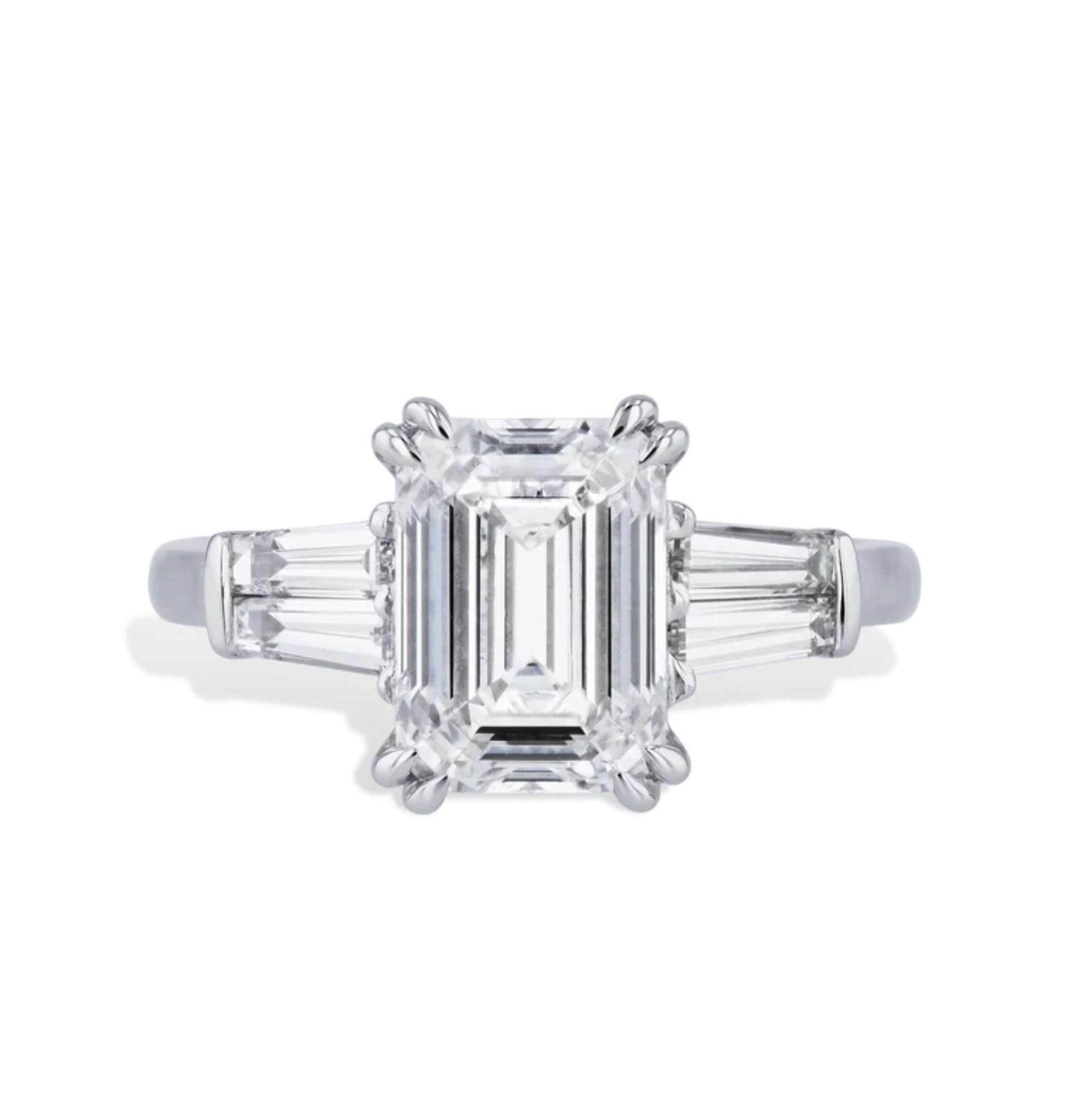 This classic emerald cut diamond estate ring boasts a stunning 3.25 carat center stone framed in glittering platinum. 
Four tapered baguettes add extra sparkle and ensure an unforgettable presence. 

The center stone is GIA certified and the number