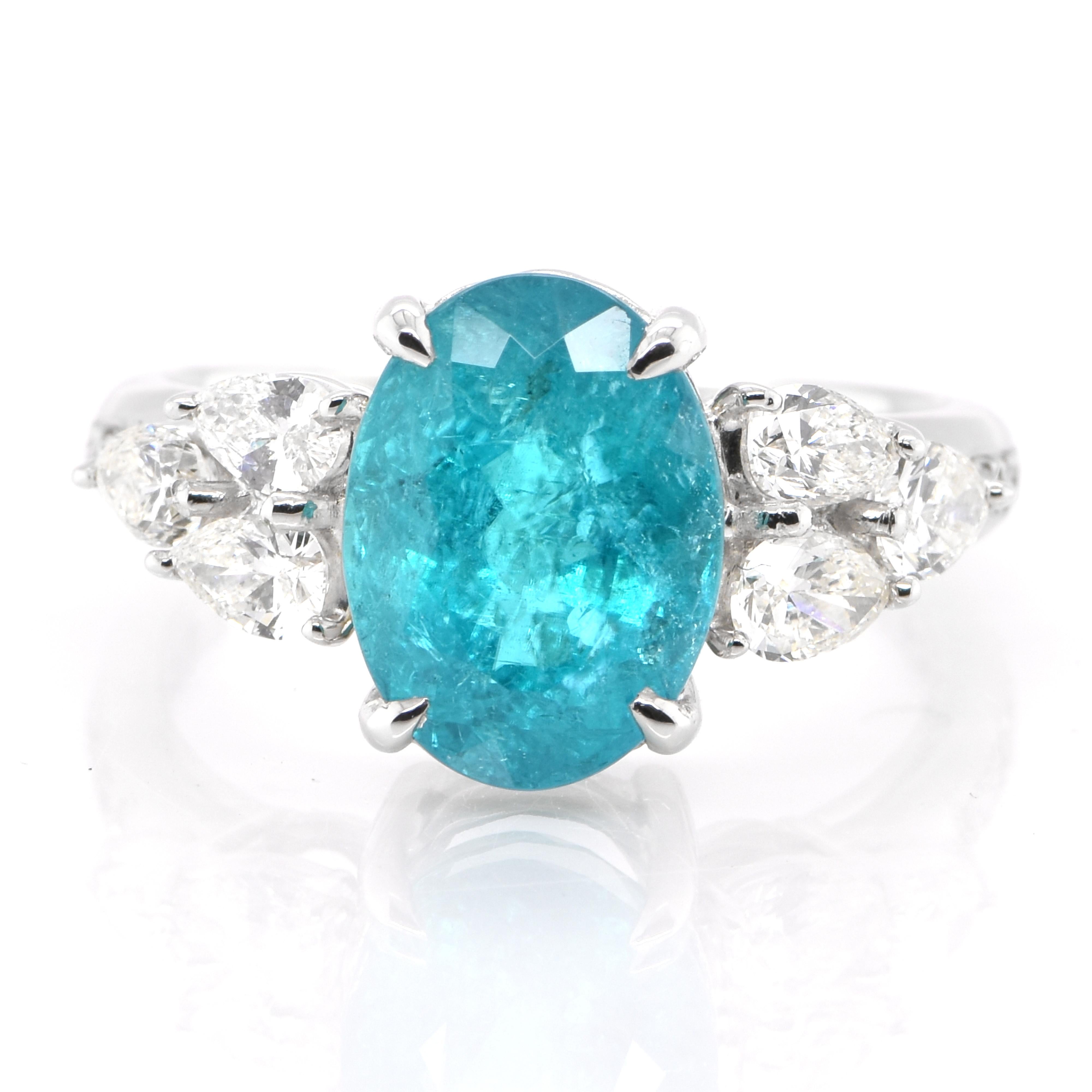 A beautiful ring featuring a GIA Certified Carat Natural Brazilian Paraiba Tourmaline and 0.71 Carats of Diamond Accents set in Platinum. Paraiba Tourmalines were only discovered 30 years ago in the Brazilian state of the same name- Paraiba. Since