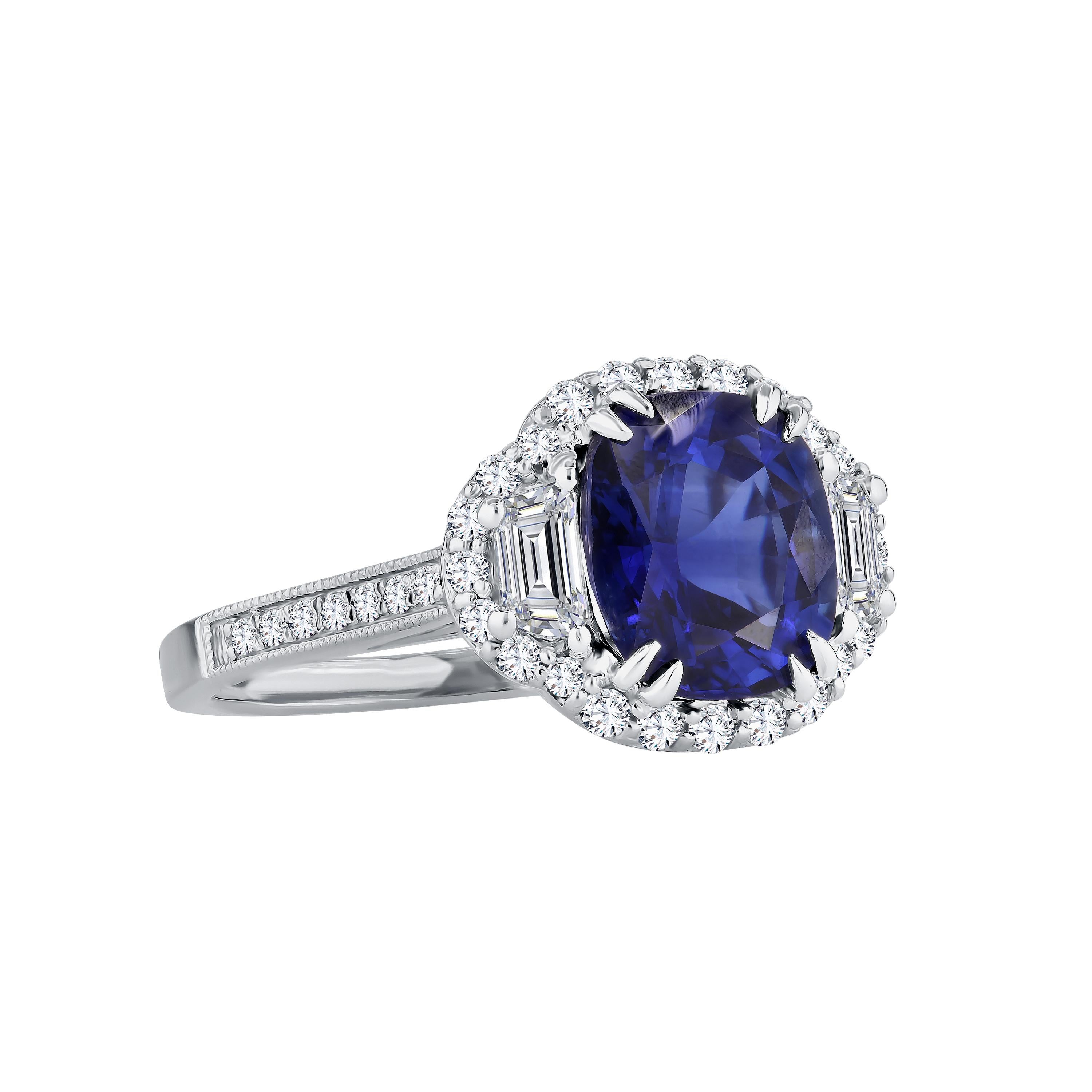 Behold this magnificent ring, graced by the presence of a GIA Certified cushion-cut vivid blue sapphire at its heart, encircled by a radiant halo of round white diamonds. Certification details can be found in the accompanying photo, showcasing the