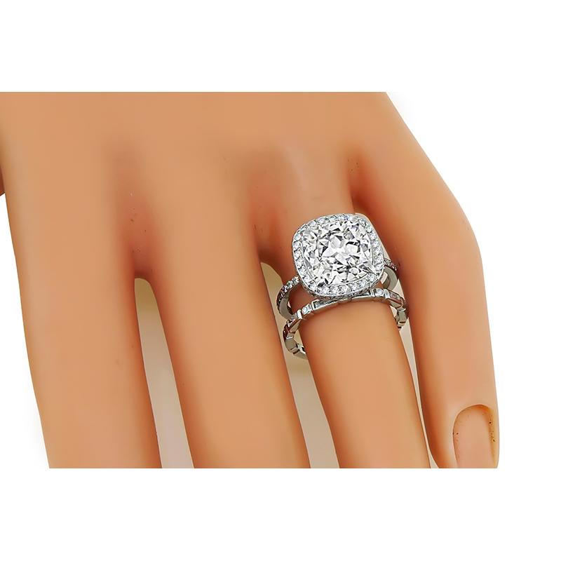 This is a stunning platinum engagement ring and wedding band set. The ring is centered with a sparkling GIA certified cushion cut diamond that weighs 3.28ct. The color of the diamond is I with SI2 clarity. The center diamond is accentuated by