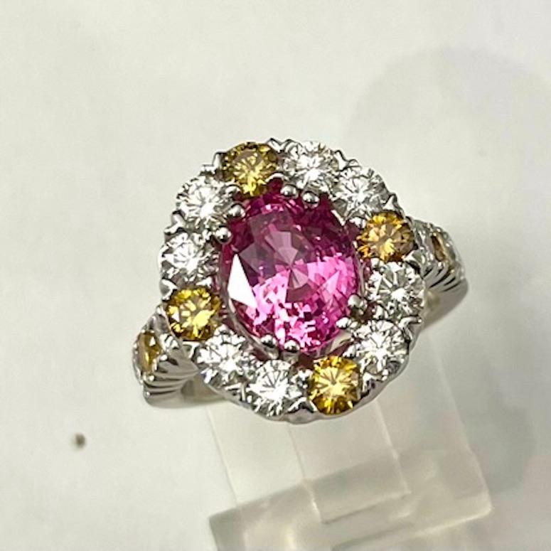 This Pink-Orange Sapphire looks very much like a Padparadscha Sapphire, which is among the most rare of sapphire colors. The hue is rich and transparent, allowing a view directly into and through the stone. It is surrounded by natural yellow and