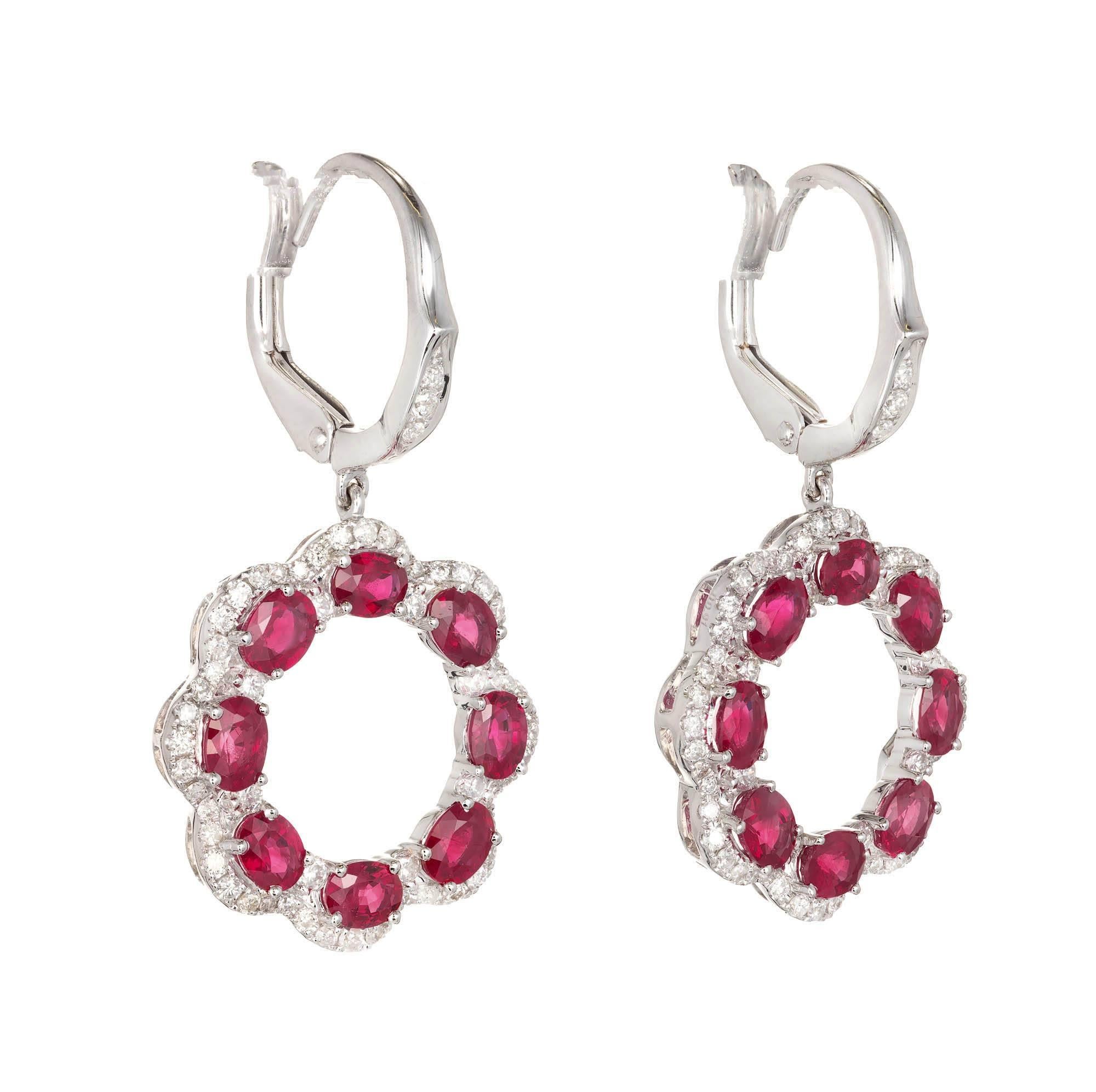 Bright red ruby and diamond dangle earrings in 18k white gold with scalloped edges. Fine white diamonds. Vivid red Rubies. Natural corundum. Heat with minor residue. GIA certified. 

Sixteen 4 x 3mm oval fine red Rubies, approx. total weight
