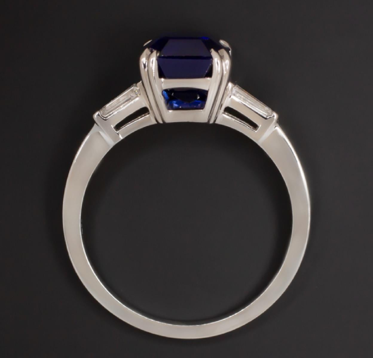 Sophisticated sapphire and diamond ring features a gorgeous emerald cut royal blue sapphire accented by tapered baguette cut diamond accents. The color of the 3.13ct GIA certified sapphire is absolutely stunning with a rich, velvety blue play of