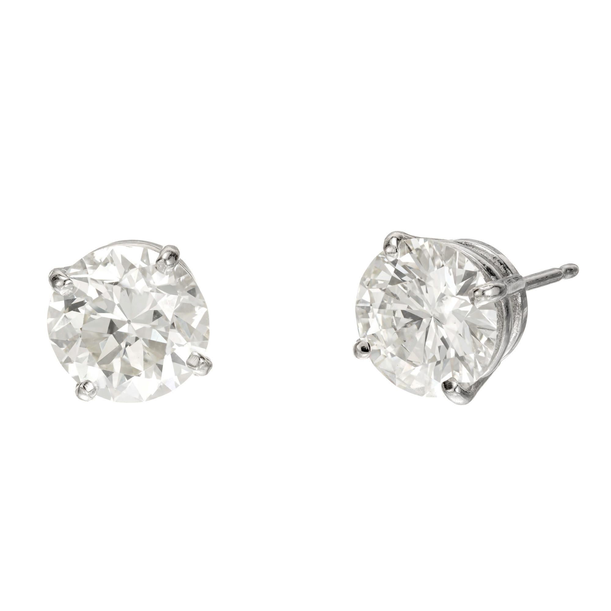 Well matched transitional cut diamond stud earrings. 2 GIA certified round cut diamonds, 1.77cts and 1.58cts set in 4 prong platinum basket settings.  circa 1945-1955 

1 round diamond, L VS approx. 1.77cts GIA Certificate # 5211643397
1 round