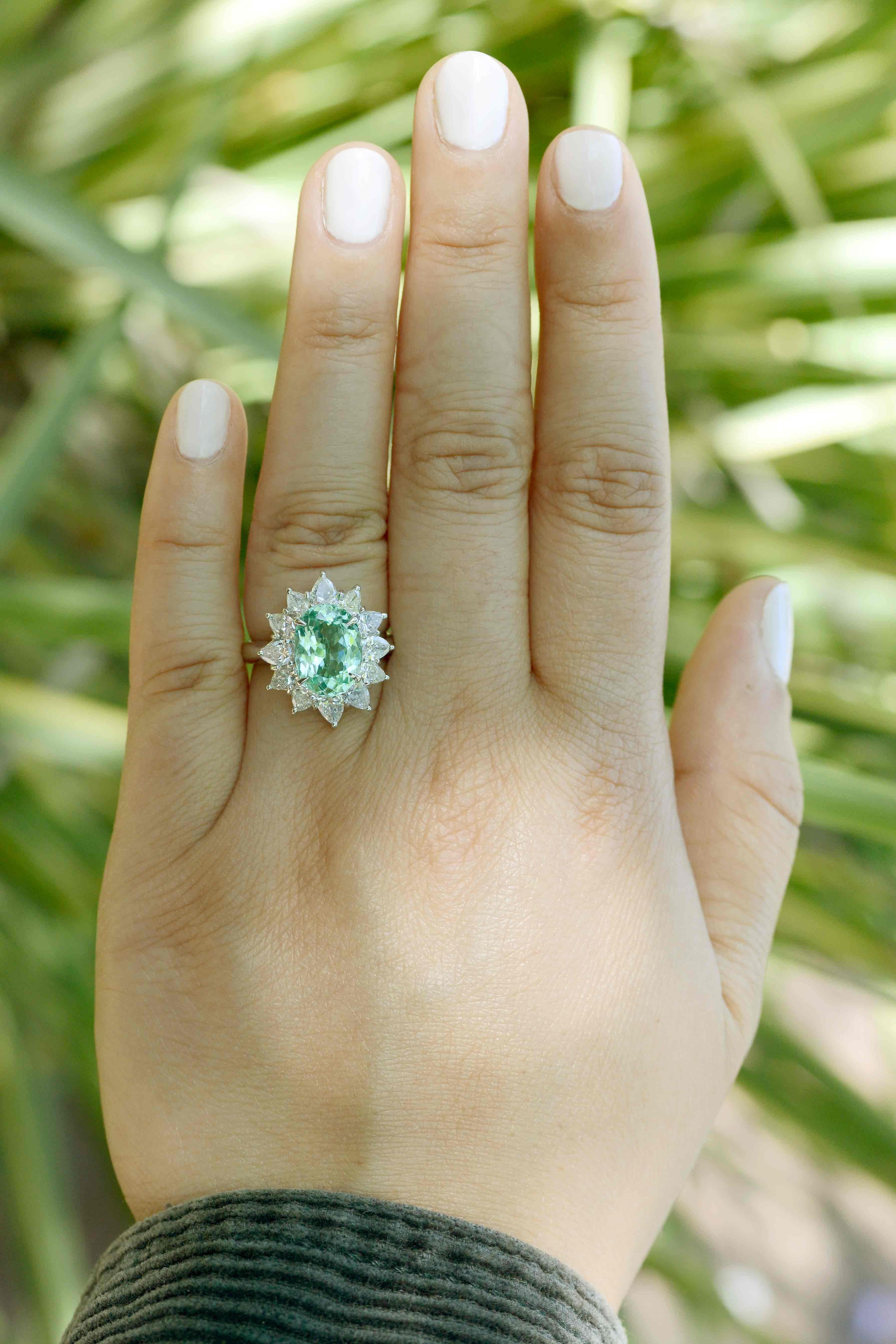 A most breathtaking, refreshing, large Paraiba tourmaline and diamond engagement ring that oozes royalty. The rare, natural gemstone of an impressive 3.35 carats has that distinctive color of the Mediterranean Sea that really pops. GIA certified as