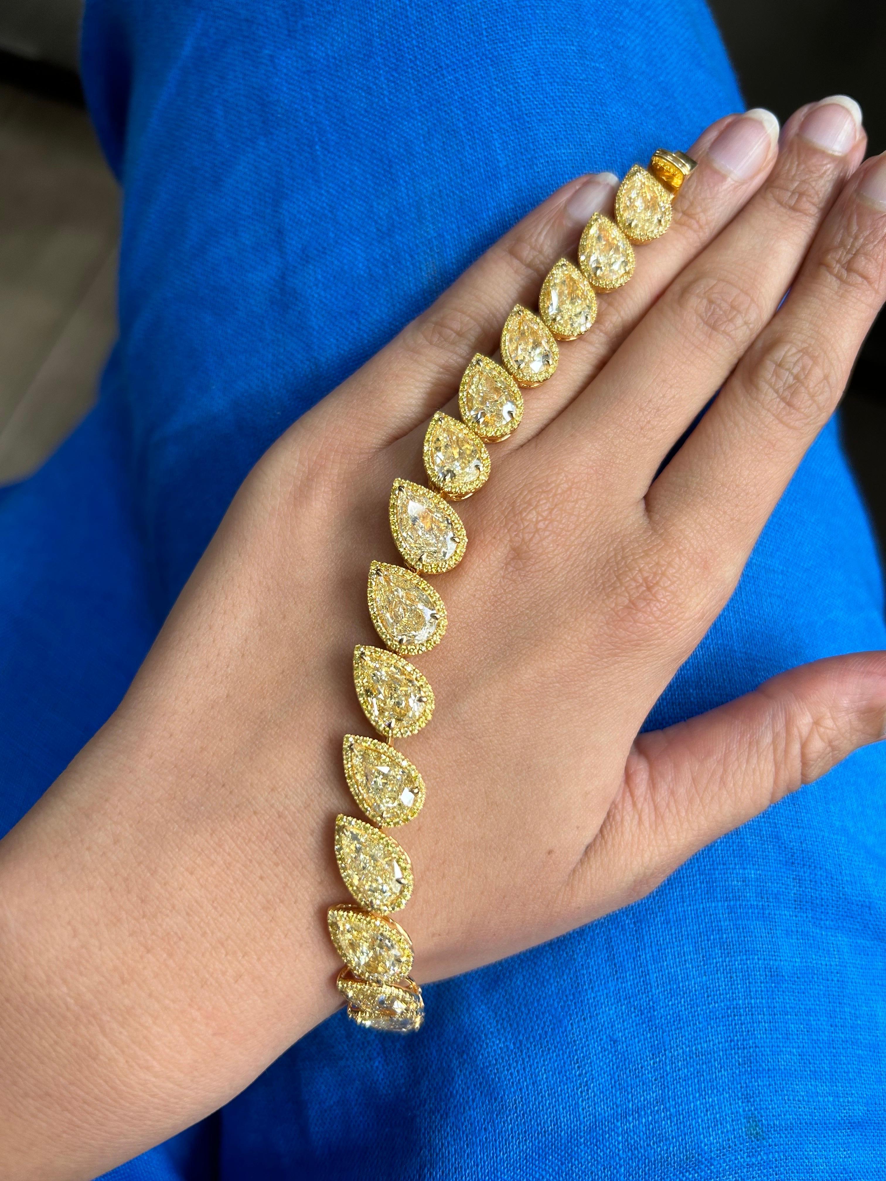 A one of a kind, all GIA certified 31.46 carats pear shape Yellow Diamonds bracelet, with 2.27 carat Yellow Diamonds surrounding them, set in solid 18K Yellow Gold. Current length is 6.5 inches long, can be customized. 
There are total of 15 pear