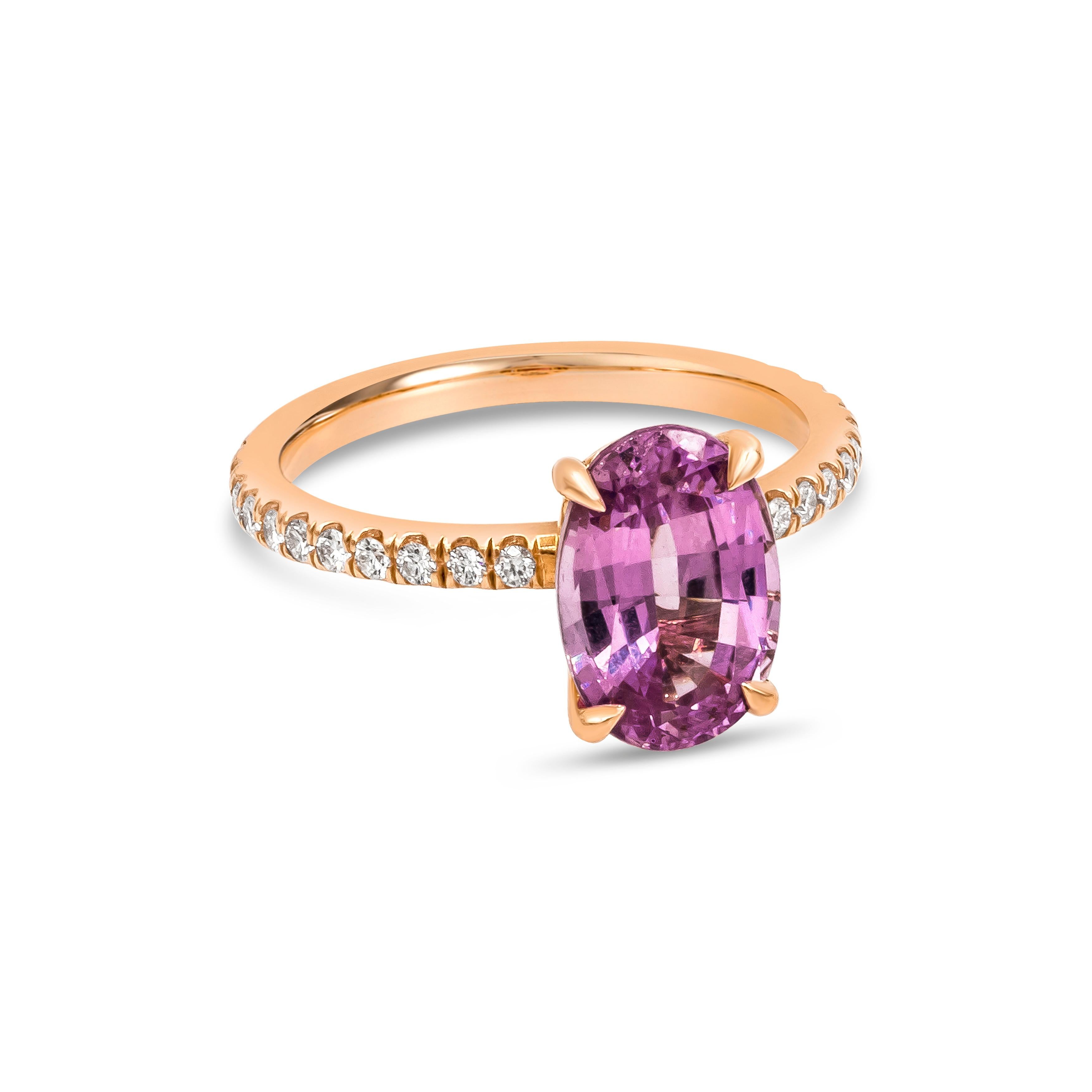 A color-rich engagement ring showcasing a 3.38 carats oval cut pink sapphire certified by GIA as no indications of heating which makes the stone more rare. Set in a four prong basket setting and encrusted with 22 brilliant round diamonds on the
