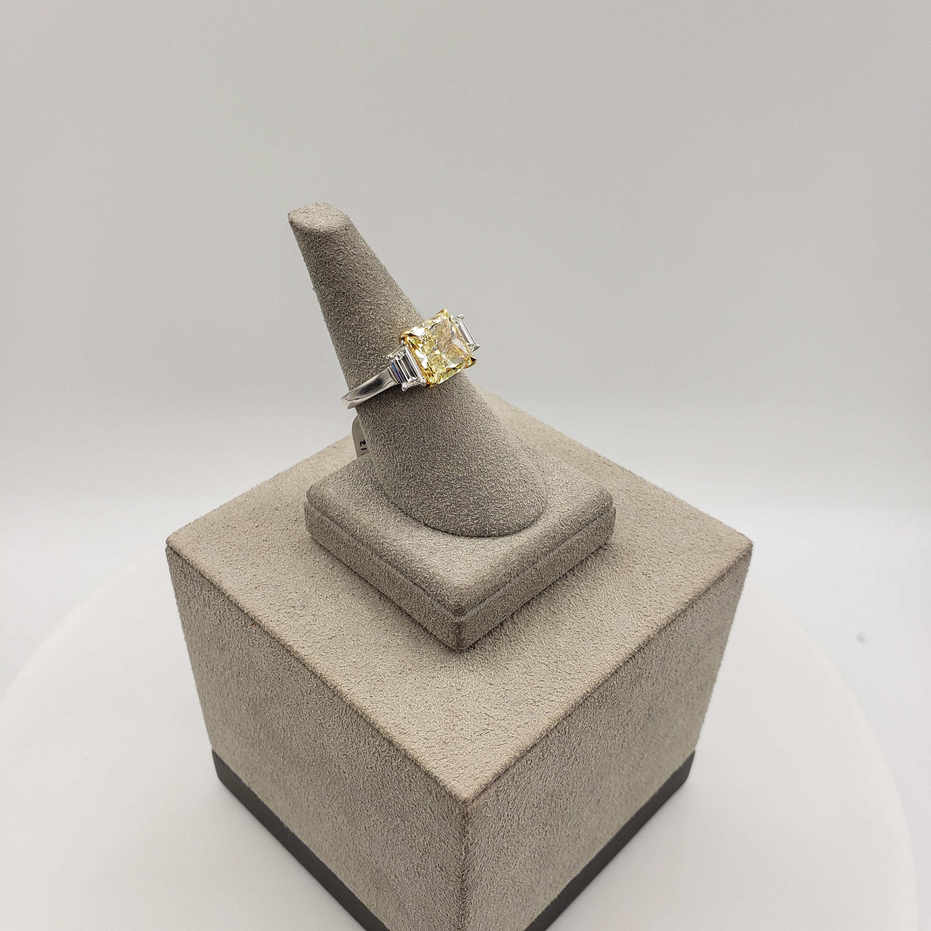 GIA Certified 3.39 Carat Radiant Cut Yellow Diamond Three-Stone Engagement Ring In New Condition For Sale In New York, NY