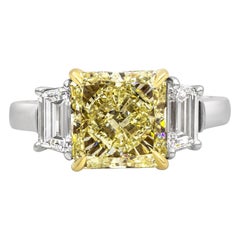 GIA Certified 3.39 Carat Radiant Cut Yellow Diamond Three-Stone Engagement Ring