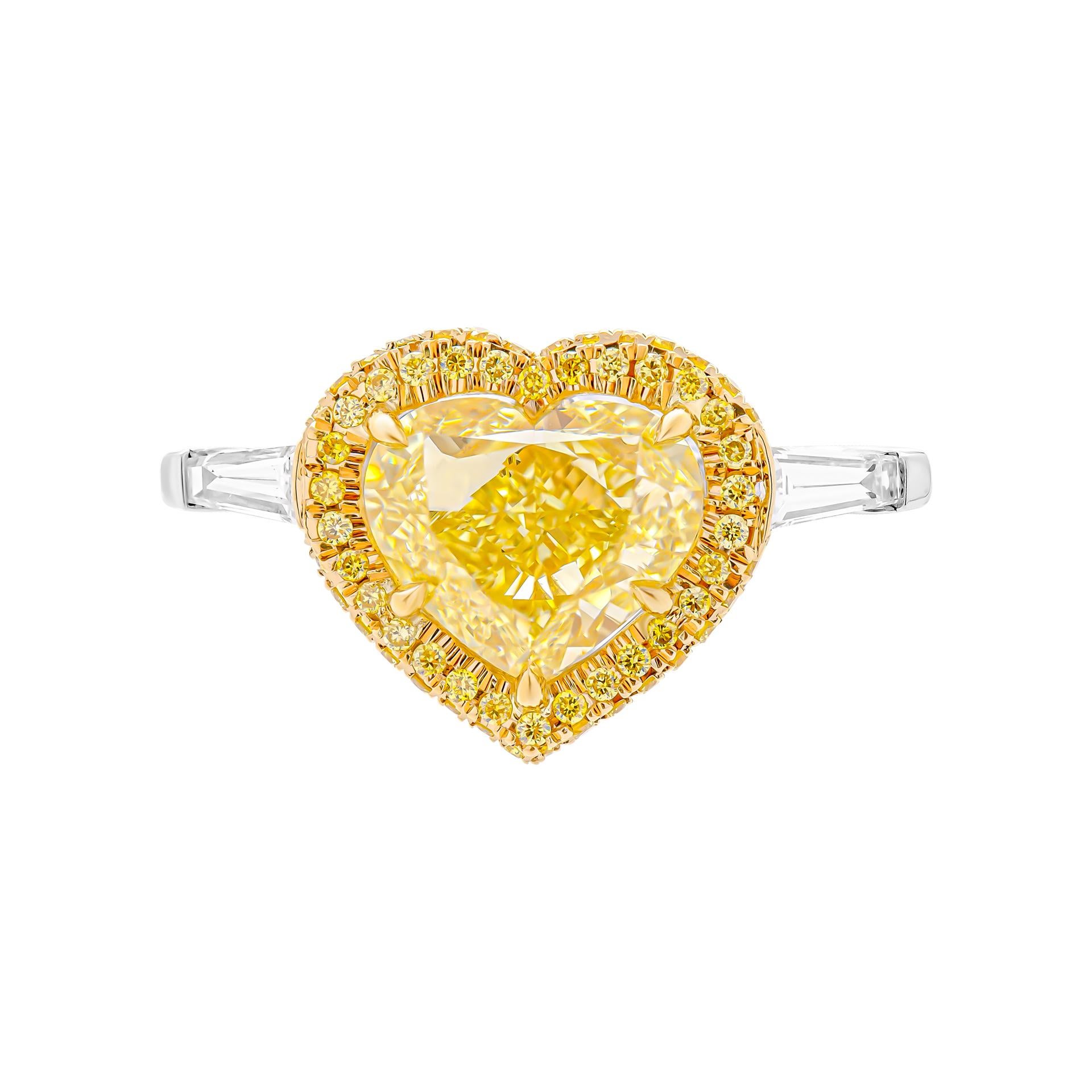 3 stone ring in Platinum & 18K Yellow Gold;
Center stone: 3.40ct Natural Fancy Yellow Even VS1 Heart Shape Diamond GIA#1437671258
Side stones: 0.31ct D VS tapered baguettes
Total Carat Weight pave Yellow: 0.26ct 
Total Carat Weight pave White: