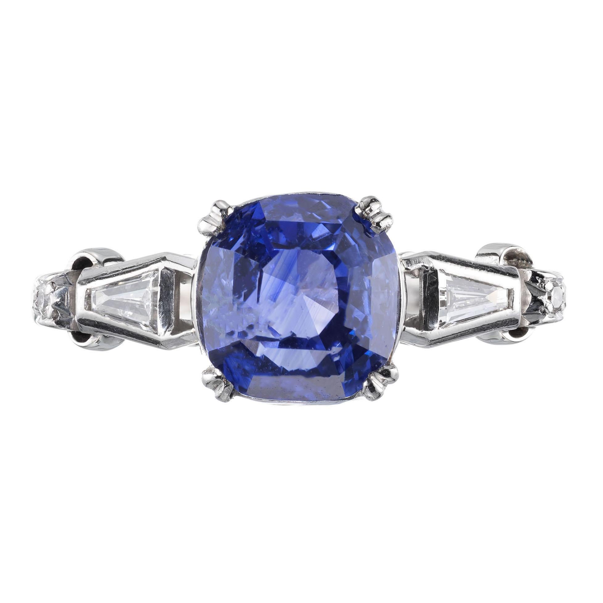 Retro 1940’s sapphire and diamond engagement ring. GIA certified, natural no heat cushion cut center sapphire with two tapered baguette side diamonds and 6 single cut accent diamonds. 18 karat white gold base and palladium top. 

1 cushion cut blue