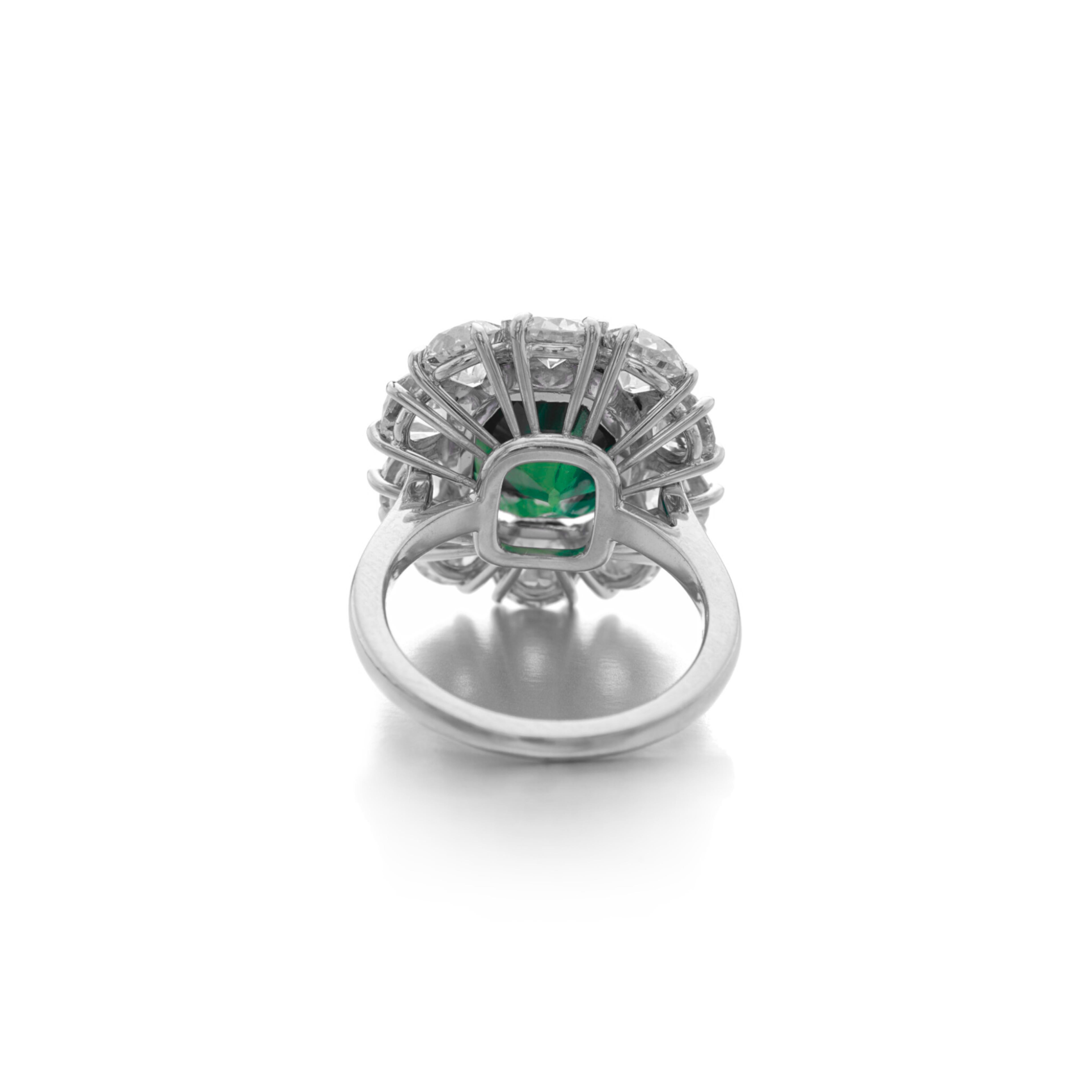 Dunaigre certified engagement ring featuring a 3.65 carat green emerald as the center stone, which is a striking choice. The emerald is complemented by natural round diamonds that boast an E-F color rating, indicating that these diamonds are also