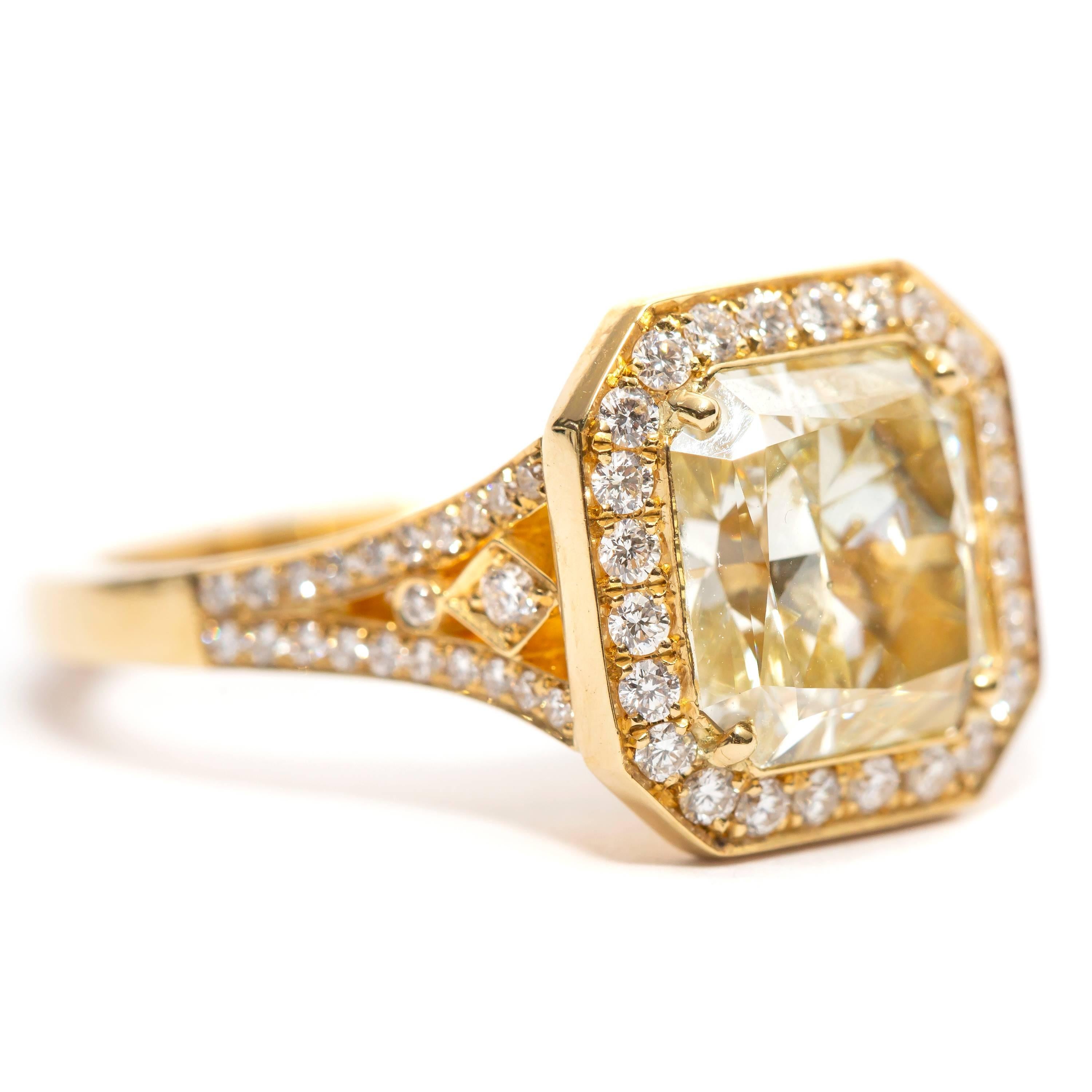 This Stunning 3.04 Carat Radiant Cut dazzling Diamond Engagement ring Color U-V Clarity SI2 featuring 0.43 Carat of White Round Brilliant Diamonds that flow down the sides of the shoulders White Color G/H Clarity SI1 set in 18 Karat Yellow Gold