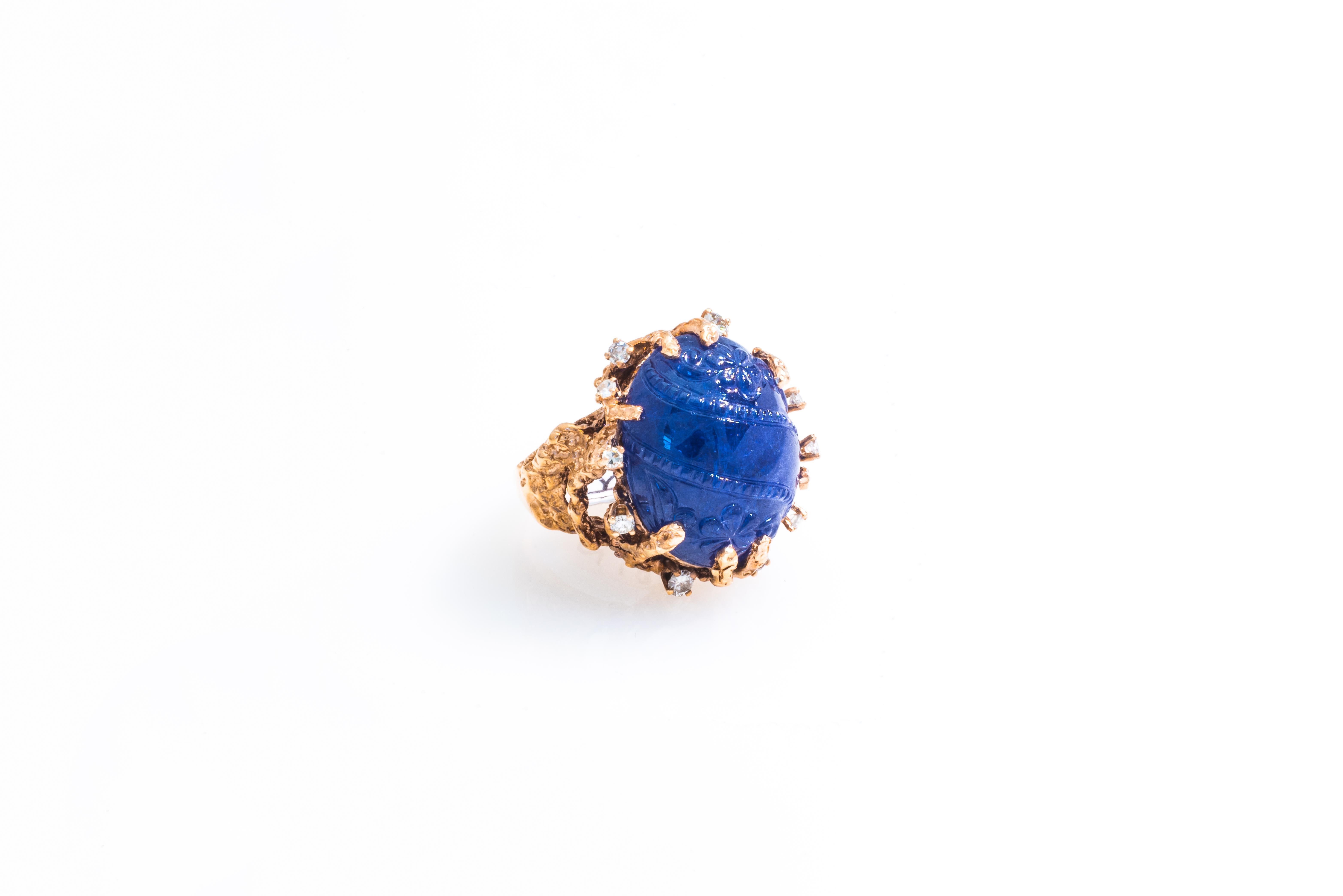 An extraordinary handmade 14K pink/rose gold ring mounted with a stunning 34.72 CT, GIA certified, oval carved Cabochon tanzanite at its center, GIA report Number: 1152207665. This magnificent gem, measuring 21.70 x 17.90 x 11.00 mm, boasts a