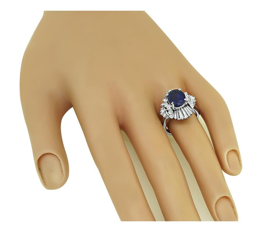 This is a fabulous platinum ring. The ring is centered with lovely GIA certified oval cut Ceylon sapphire that weighs 3.49ct. The sapphire is accentuated by sparkling round and baguette cut diamonds that weigh approximately 1.15ct. The color of