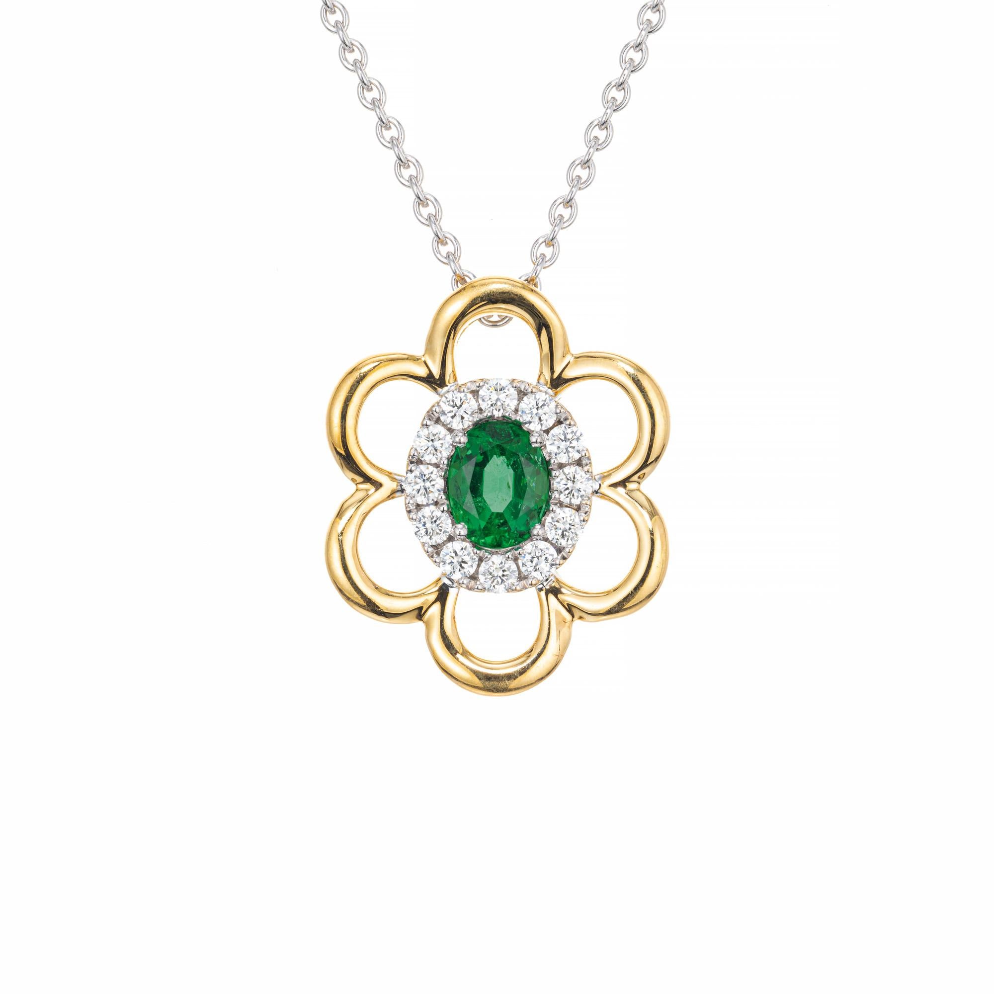 Emerald and diamond pendant necklace. GIA certified bright green oval emerald, set in a 14k white and yellow gold flower setting with a halo of 12 round cut diamonds by manufacturer Spark. 18 inch 18k white gold chain. 
Follow us on our 1stdibs