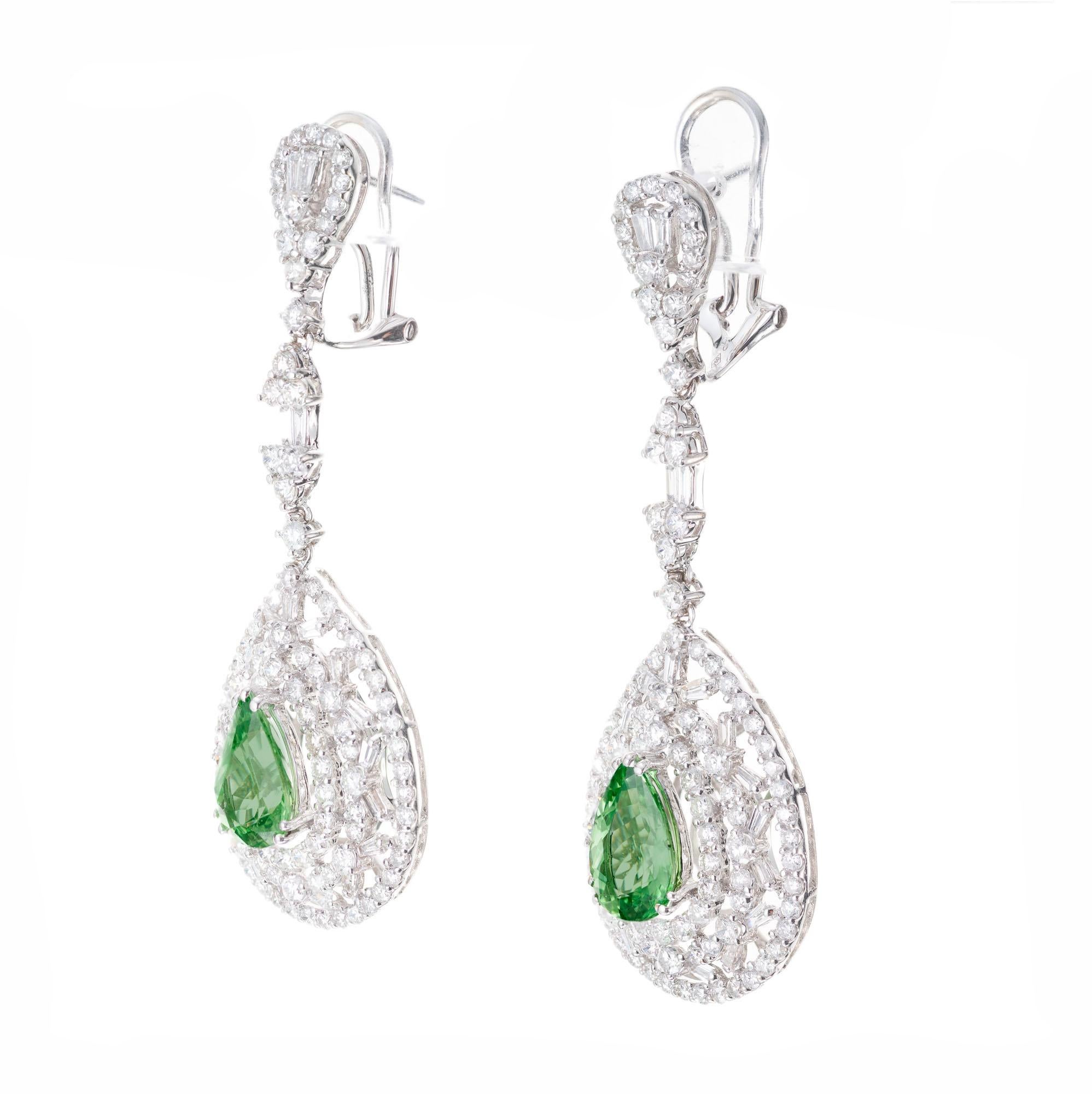 Tsavorite and diamond dangle earrings. Two center pear shaped green Tsavorite garnets in an open work 18k white gold setting round and baguette cut accent diamonds. GIA certified. 

2 pear Tsavorite garnets, approx. total weight, weight 3.50cts, VS
