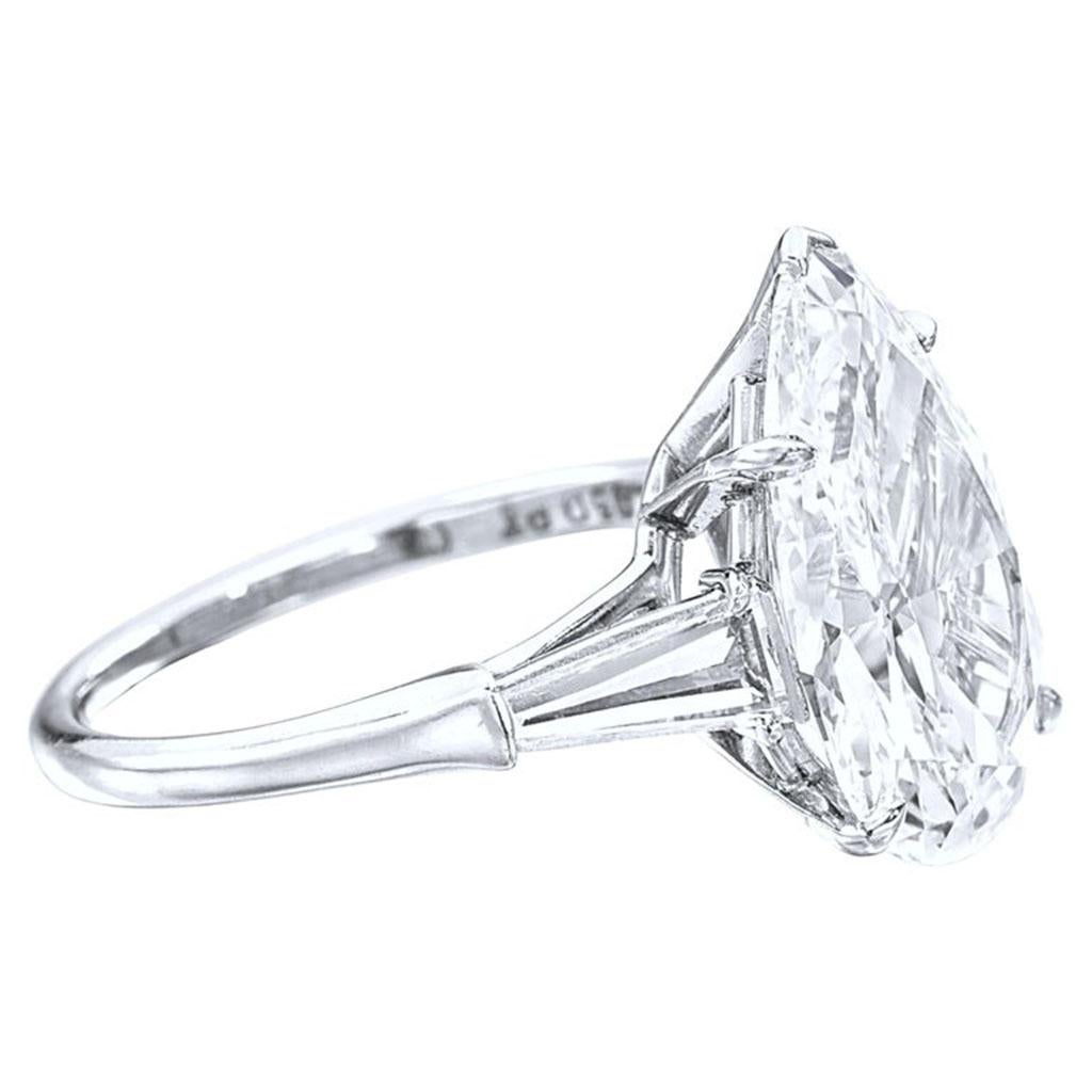 This elegant ring showcases a 3.01 carat pear cut diamond, GIA certified for its superb quality, set in luxurious platinum. 
The central diamond is accented by tapered baguette diamonds on either side, creating a sleek and refined silhouette.