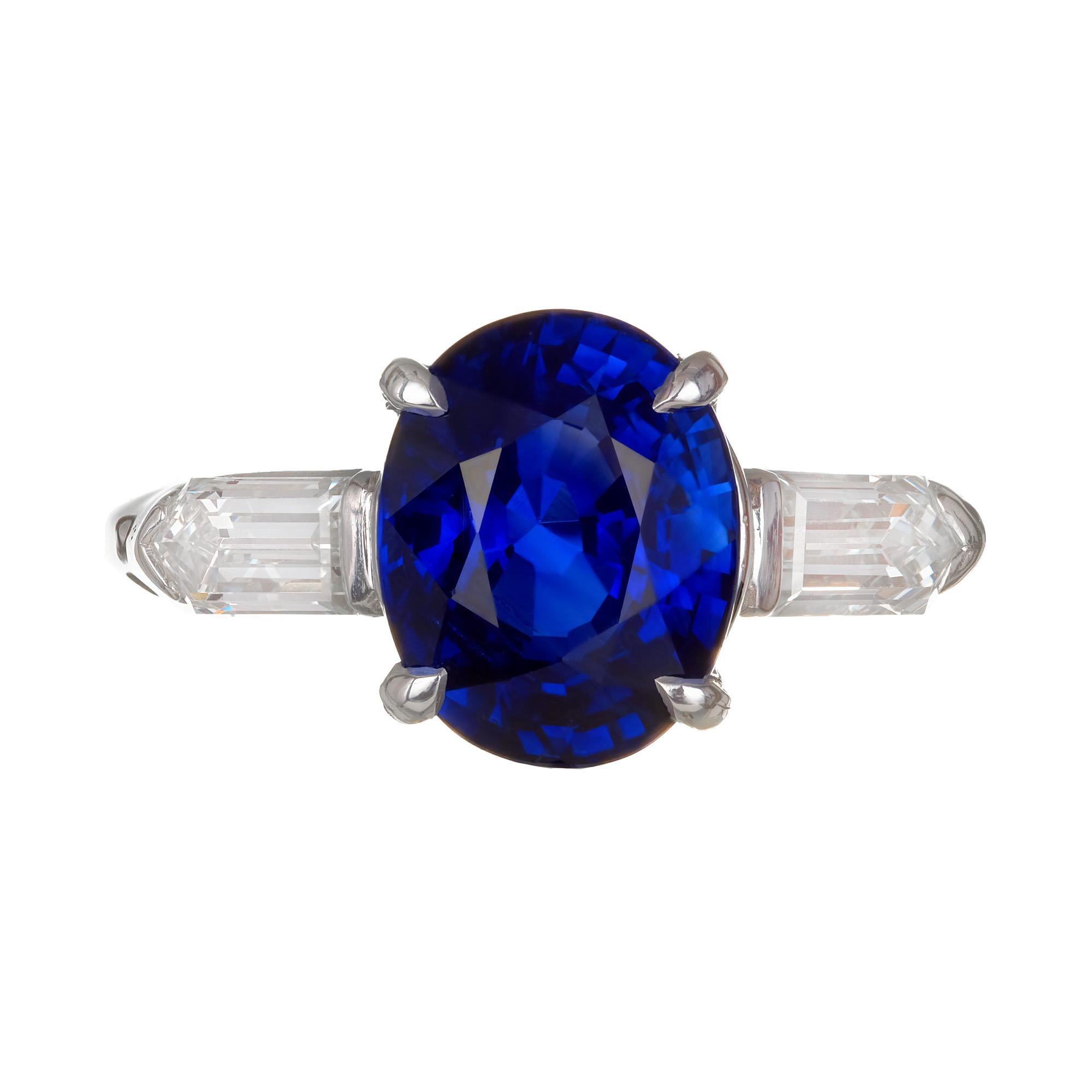 Bright blue oval sapphire and diamond three-stone engagement ring. 14k white gold setting accented with white bullet shaped diamonds. Circa 1950s. GIA certified oval sapphire center stone. 

1 oval blue VS-SI sapphire Approx. Total Weight 3.51cts. 