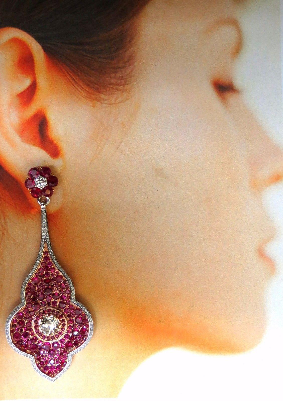 Posh Dangle Premier Elegance.

Ruby Diamonds Cluster & Bead set Dangle Earrings.

6.80ct natural round brilliant rubies (Upper Cluster)

& 22.00ct. smaller bead set Rubies throughout.

Rubies: Rounds , Full Cuts.

Transparent, clean clarity & even