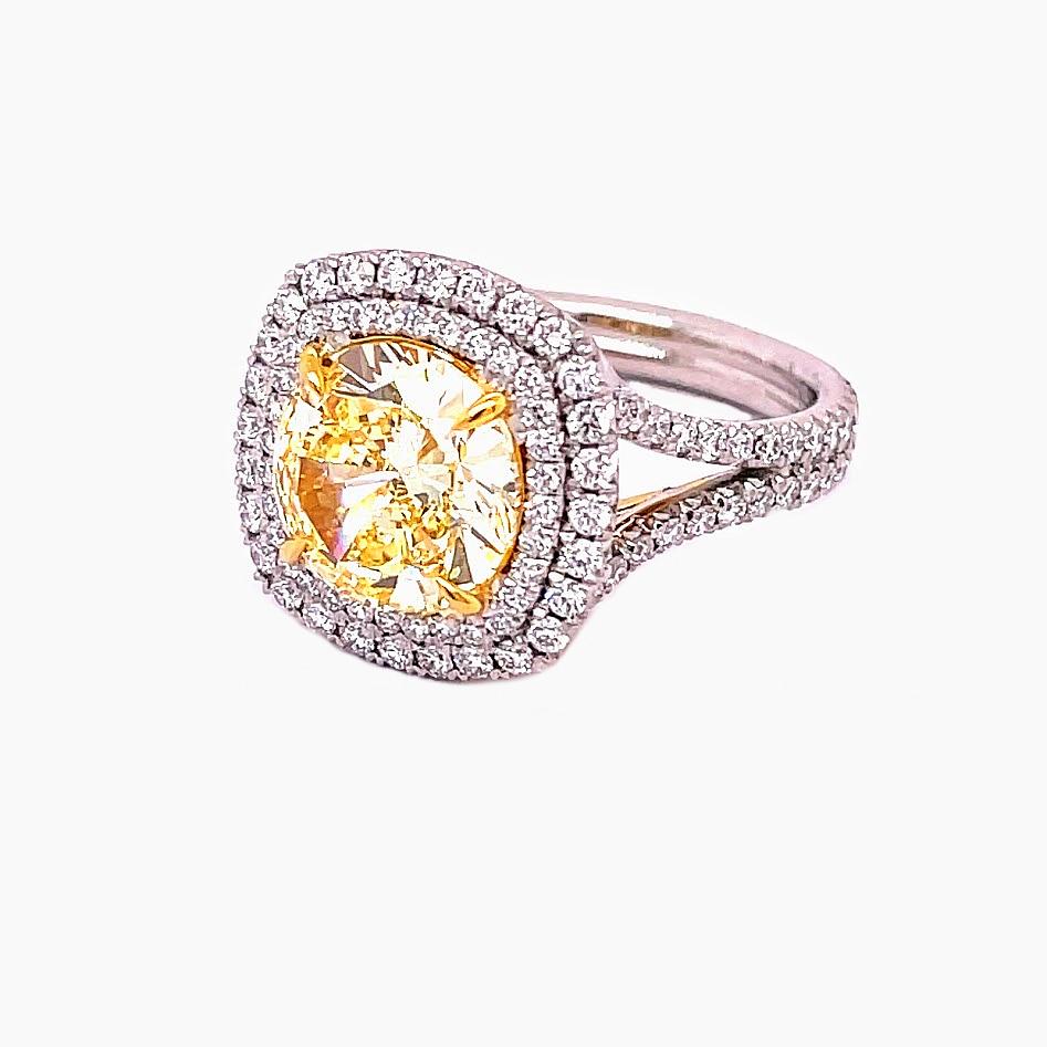 GIA Certified Round Diamond 3.53, Fancy Yellow Color IF Clarity sits gorgeously on a 18K Yellow basket with claw prongs. Surrounded by a double halo and its split shank filled by 1.34 carat round diamonds. A ring made to perfection with the highest