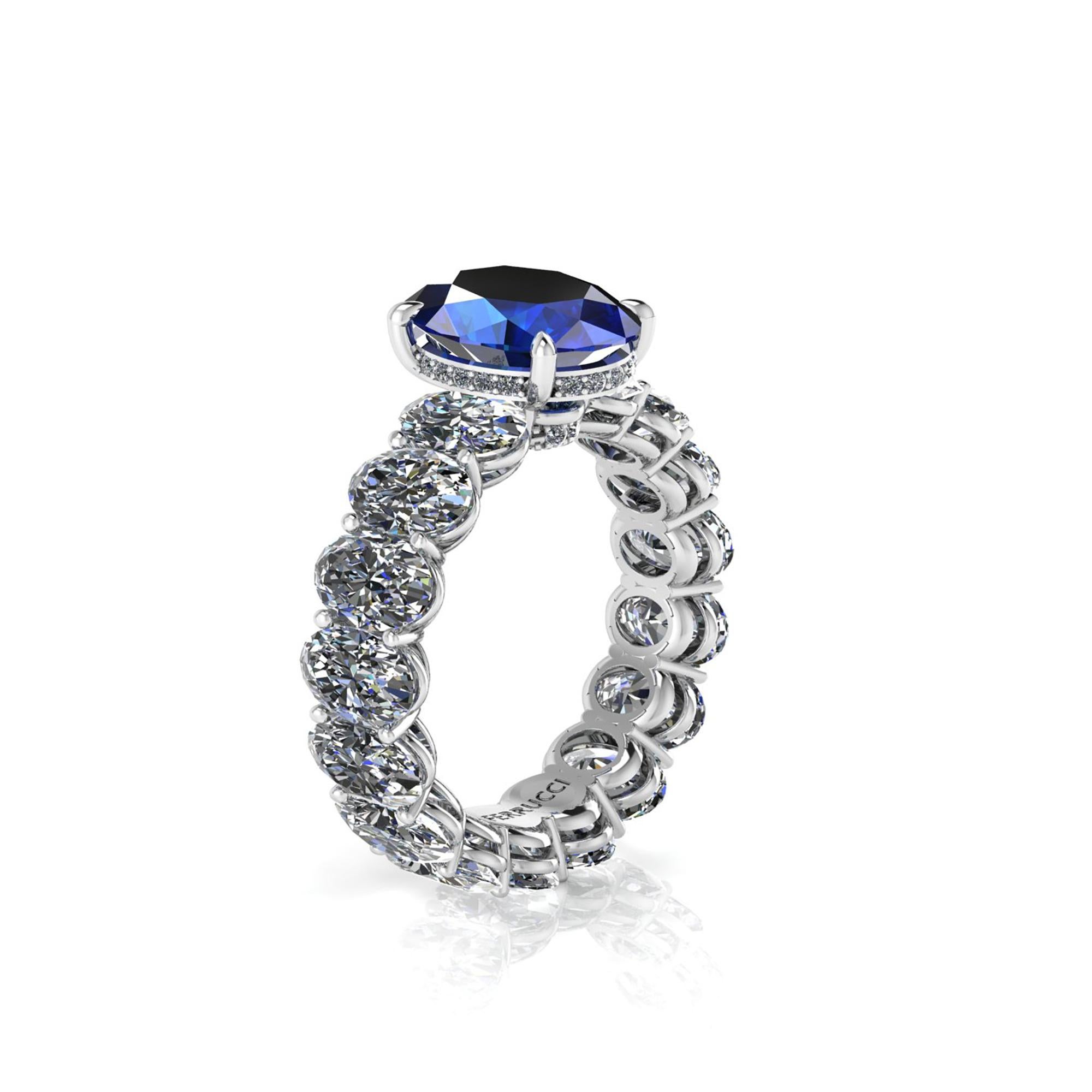 GIA Certified 3.34 Carat  Blue Sapphire, set on a Platinum 950, Oval diamond eternity ring, designed and hand made in New York with the gem adorned by pave of white round diamonds, for a total diamond carat weight of 5.10 carats, color H, clarity
