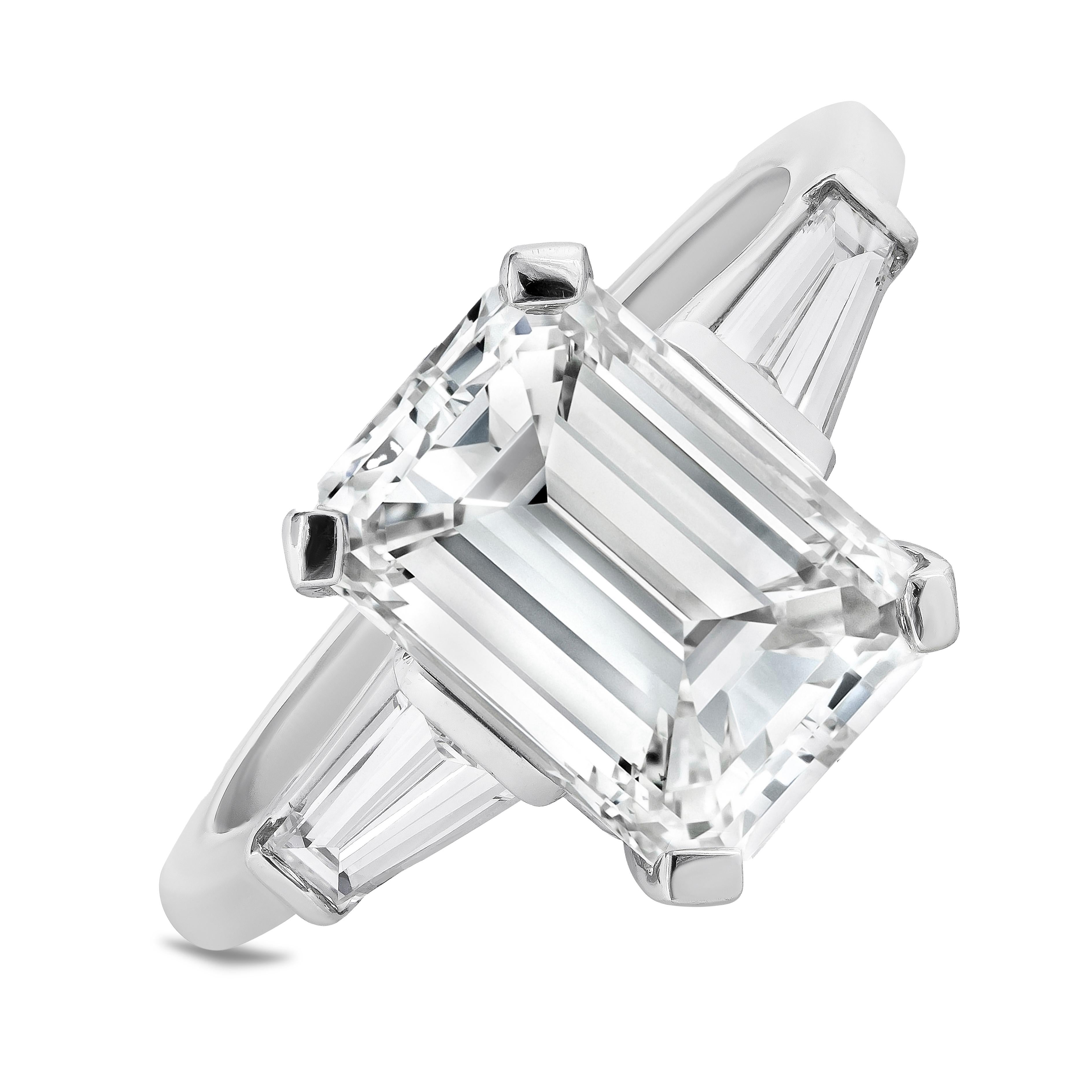 A stunning engagement ring, featuring a 3.57 carats emerald cut diamond certified by GIA as J color and VVS1 clarity, set on a four prong setting. Flanked by two tapered baguette cut diamonds weighing 0.42 carat total. Finely made with a platinum