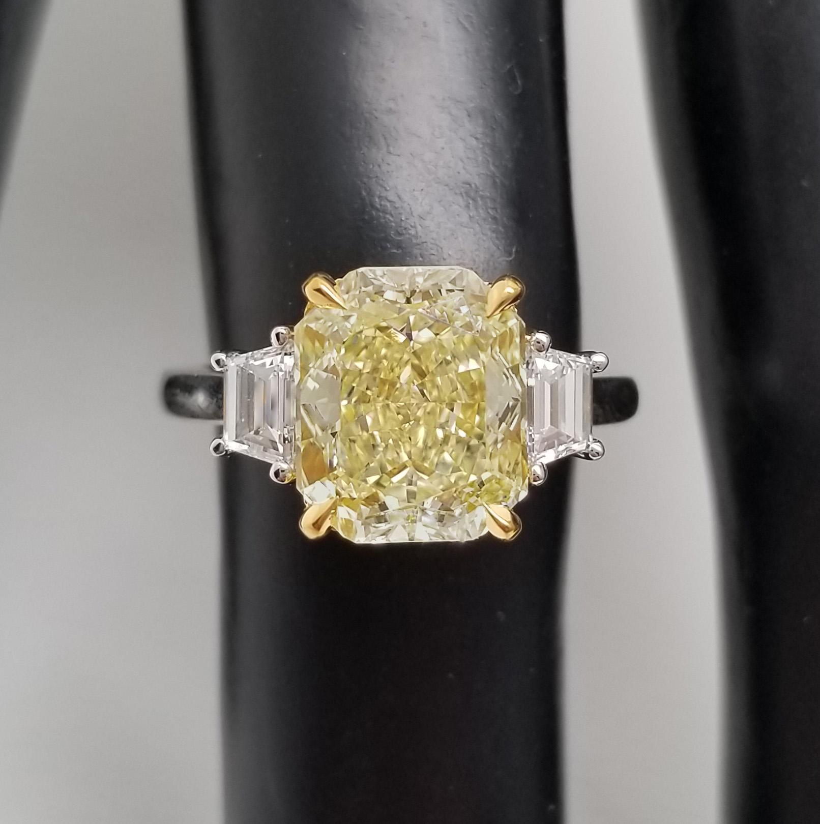 Engagement ring from Scarselli Diamonds with internally flawless, 3.57 carat radiant cut natural fancy yellow color center stone. Three-stone style engagement with 3.57 carat center stone - internally flawless natural fancy yellow in a radiant cut,