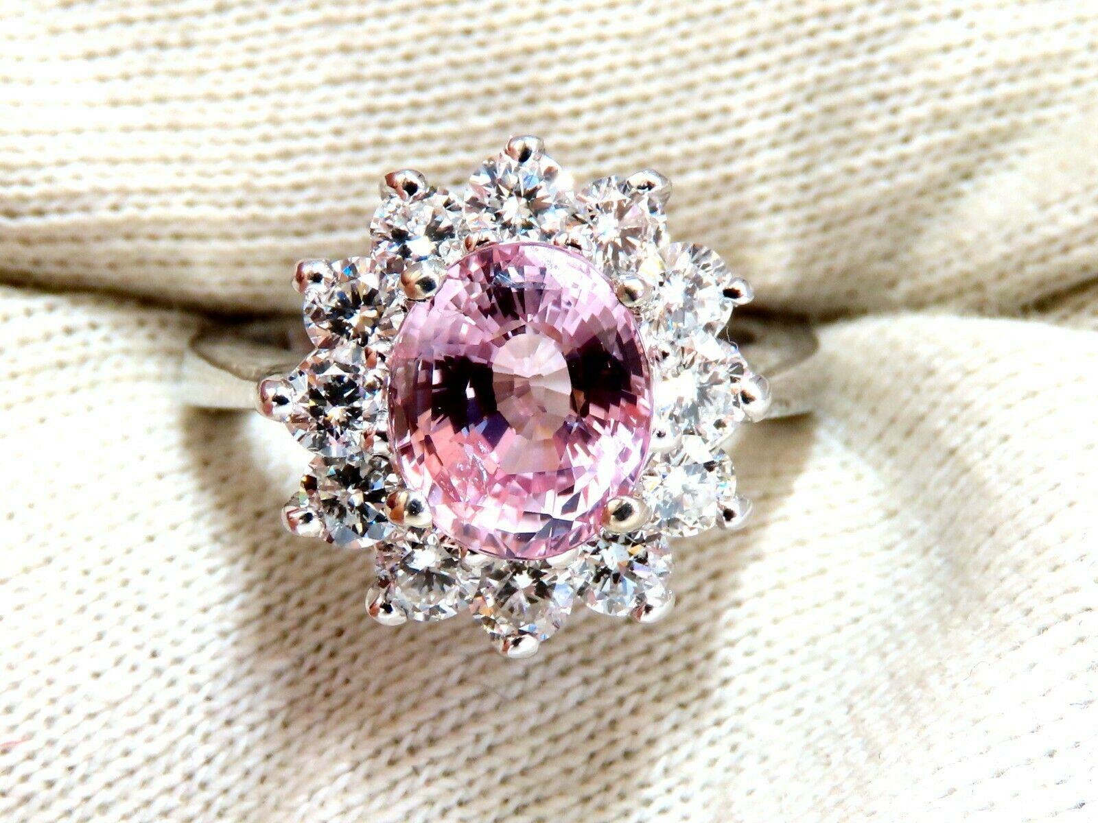 Classic Halo Cluster

GIA Certified 

3.58ct. Natural Padparadscha Pink Sapphire ring.

Report:  6197433099

Oval cut: 9.16 x 7.61 x 5.70mm

Clean (VS) Clarity, Transparent

Even Pink-Orange Color



1.70ct. Side natural Round diamonds

G color,