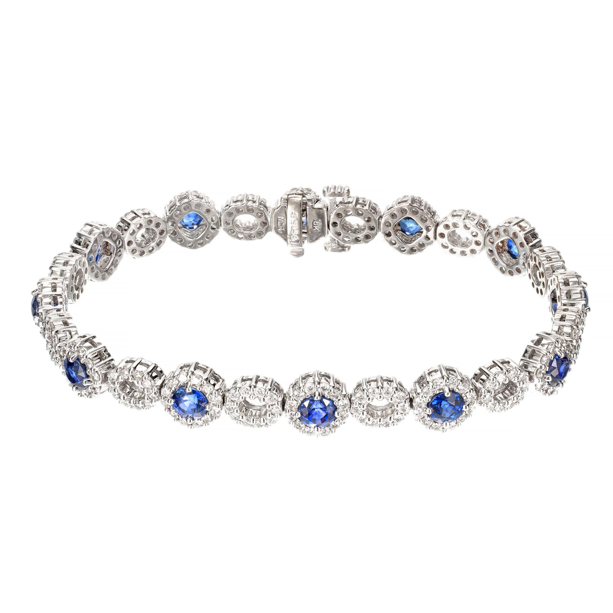 This sapphire and diamond bracelet crafted in 18k white gold, features 12 oval shaped halos of round brilliant cut diamonds 

12 round blue sapphires, approx. 3.60cts GIA certificate # 5202989562
264 round brilliant cut diamonds, H-I SI approx.