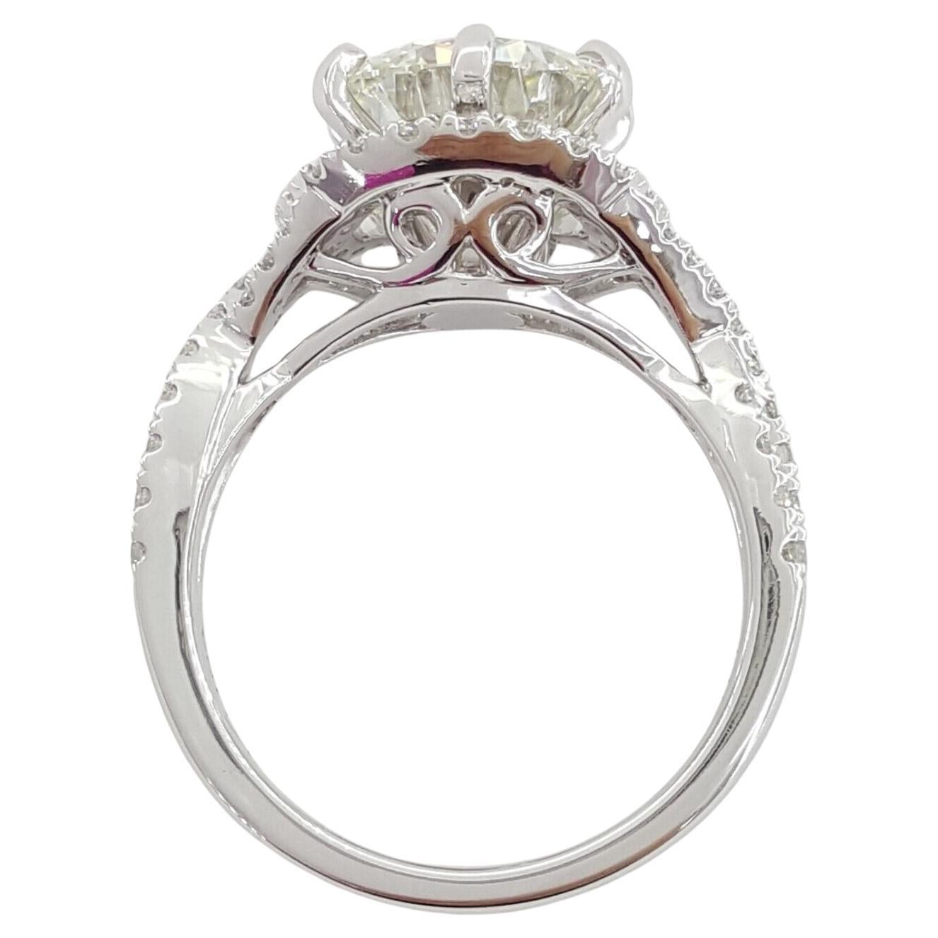 Presenting an extraordinary symbol of love and devotion: the 3.62 ct Total Weight Round Brilliant Cut Diamond Crossover Halo Engagement Ring, elegantly crafted in 14K White Gold.

Weighing a total of 6 grams and sized at 6.5, this ring is adorned
