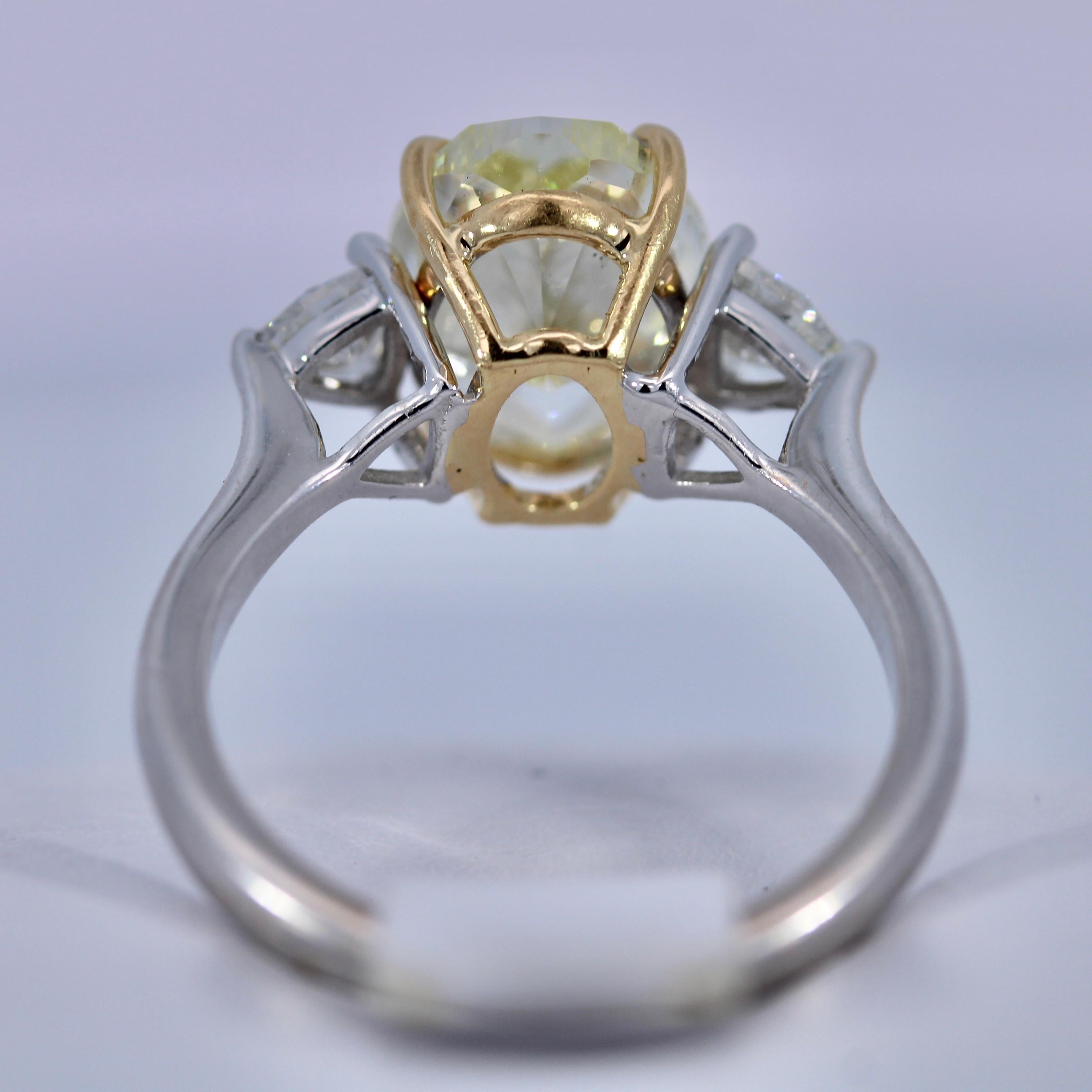 GIA Certified 3.67 Carat Light Yellow Diamond 18K White Gold Solitaire Ring 
Oval shape of Yellow Diamond
0.30 Carat of side diamonds
Measurements: 11.11 x 8.03 x 5.13 mm
Weight of ring: 4.4g
Size of ring: 5.5 US (resizable)
GIA Certificate