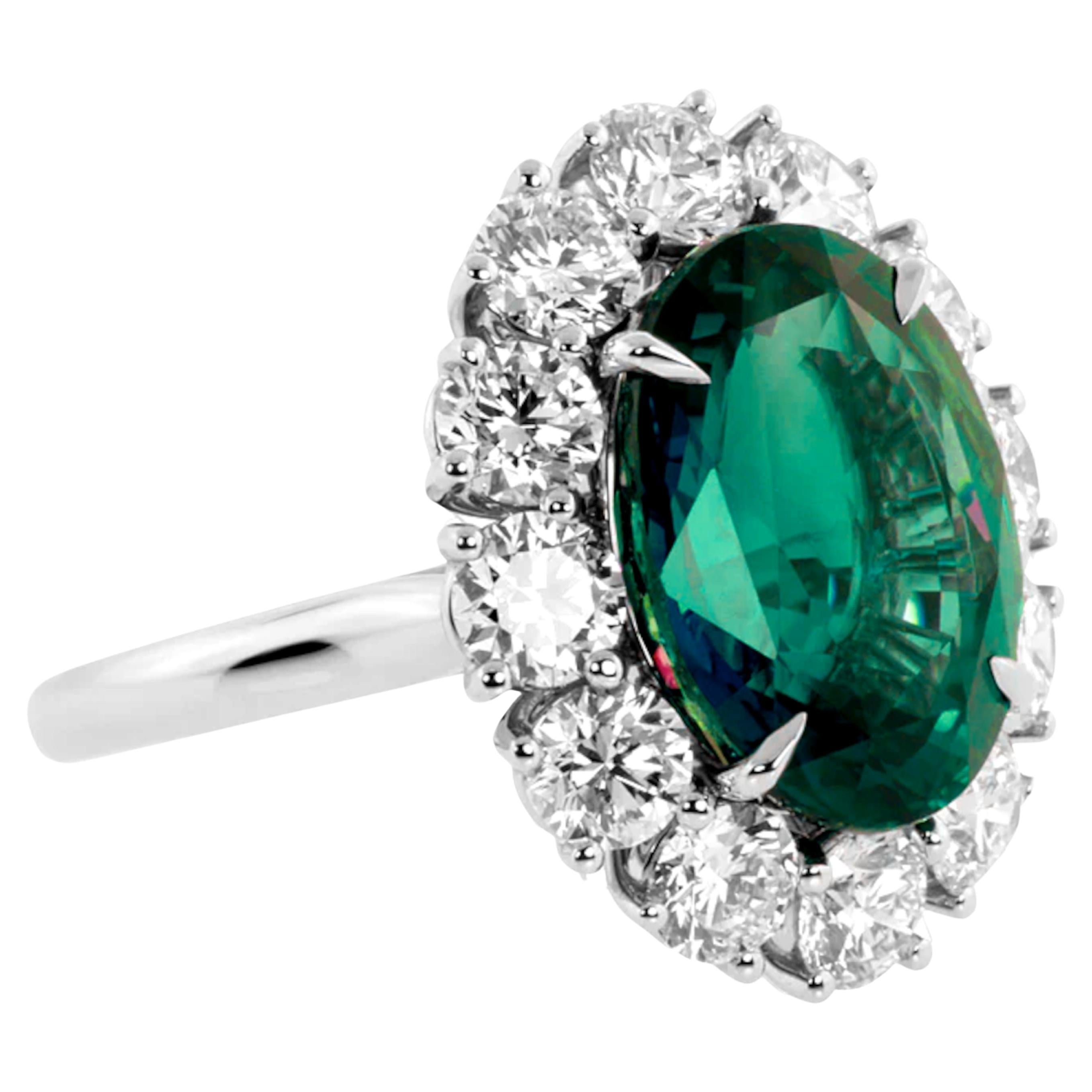 Indulge in timeless elegance with this breathtaking ring, featuring a substantial 3.67-carat oval natural emerald, certified by GIA. 

Encircled by a dazzling halo of brilliant-cut diamonds, this masterpiece is mounted in platinum for a luxurious
