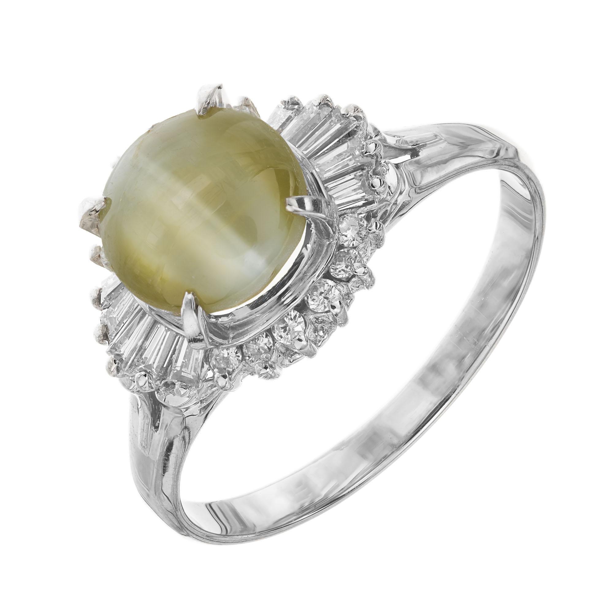 Chrysoberyl cats eye and diamond engagement ring. GIA certified oval chrysoberyl center stone with a halo of baguette and round brilliant cut diamonds in a platinum setting.  

1 oval greenish yellow cats’ eye chrysoberyl, approx. 3.69cts GIA