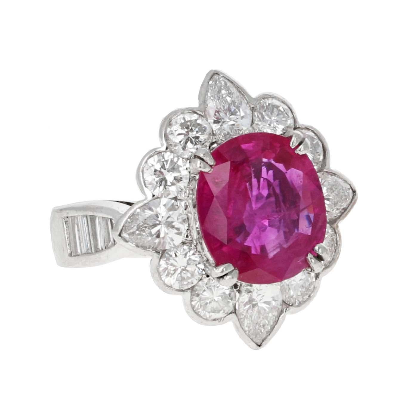 GIA-certified 3.71-carat Burma heated ruby and diamond cocktail ring. The Burma ruby is an oval cut Purplish Red color measuring 10.57 x 9.40 x  4.00mm. Elegantly set in platinum the ruby is accented with a 2.28 carat diamond halo. The mesmerizing